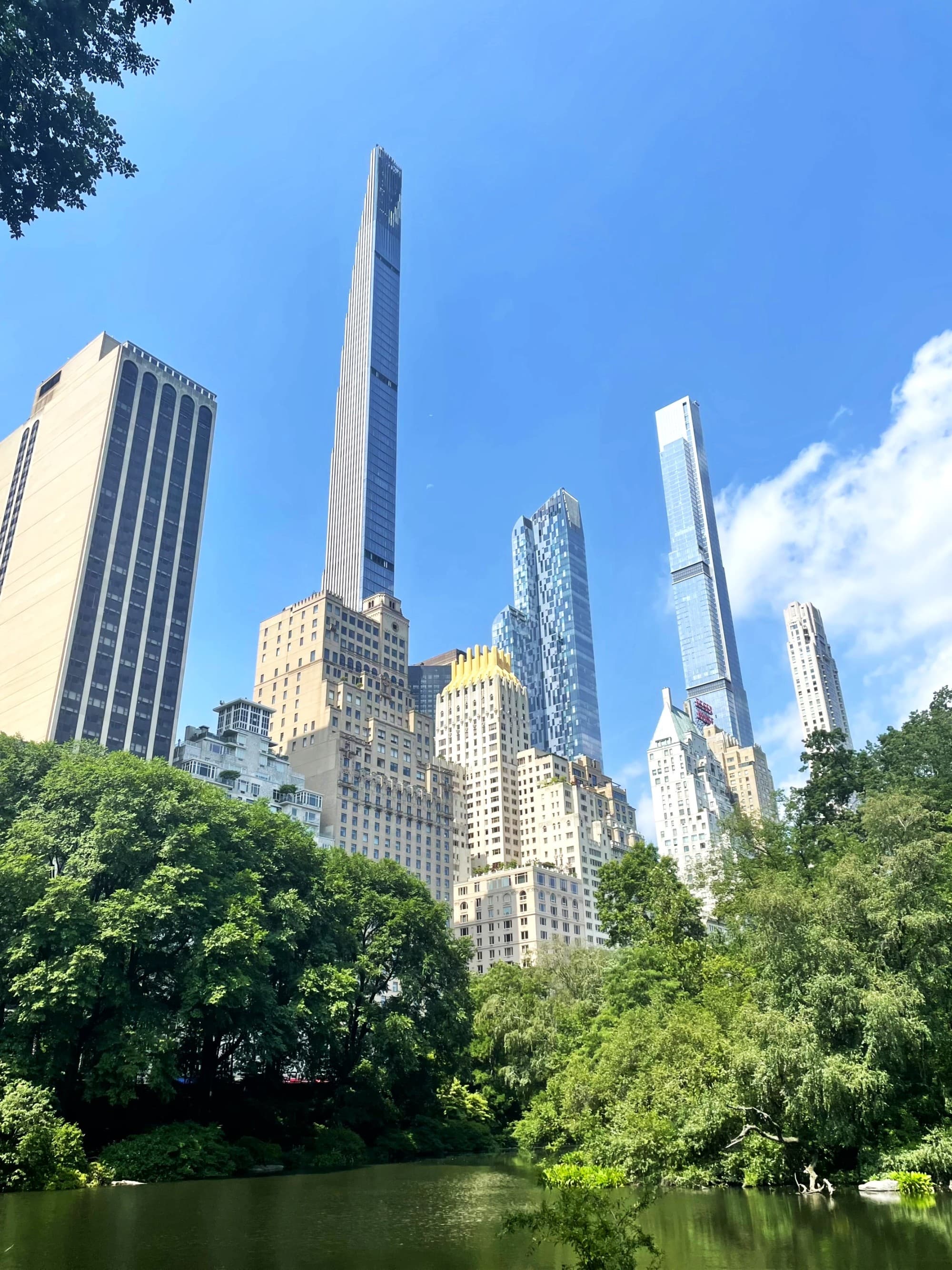 A low-angled shot of Central Park with tall buildings during daytime,