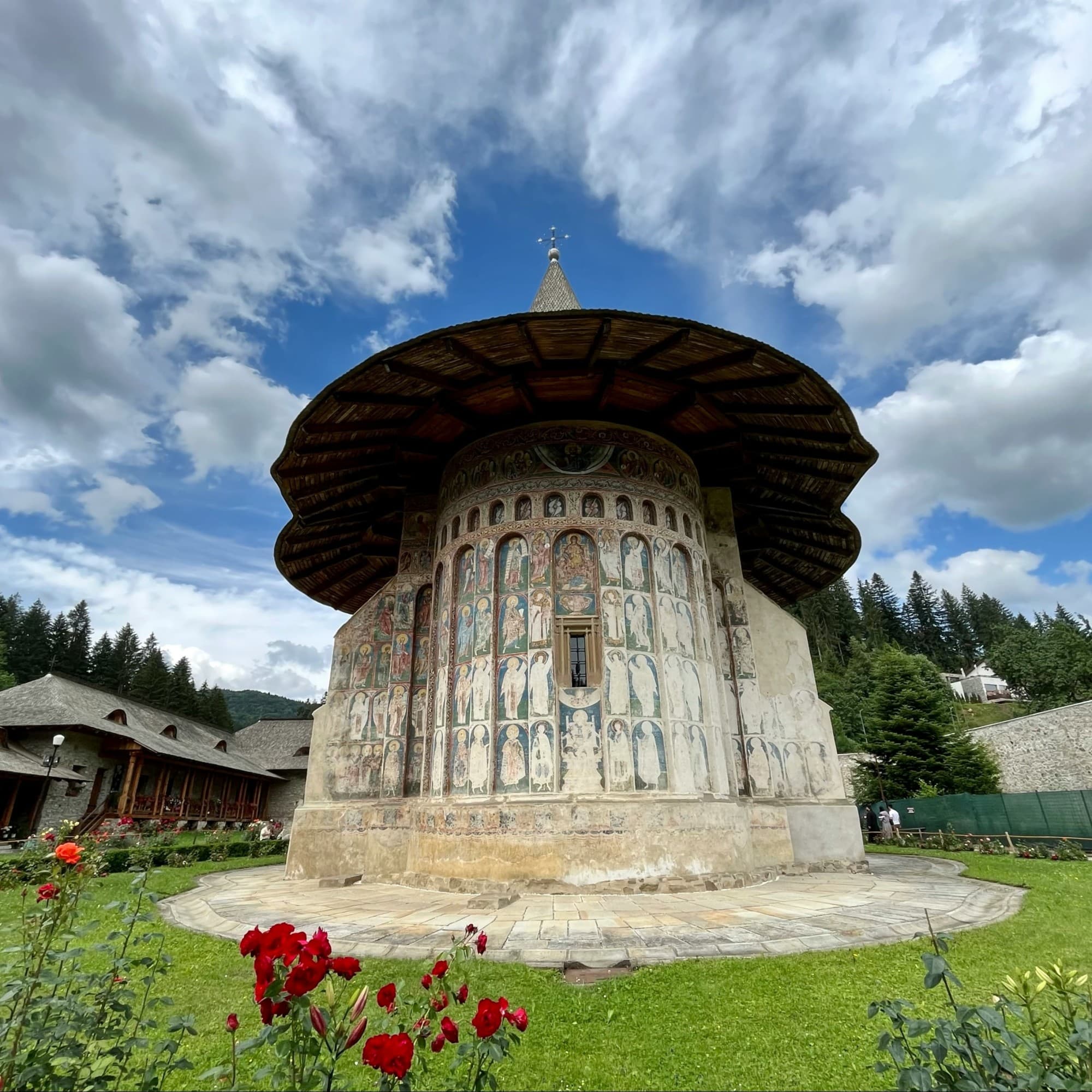 White monastery in a garden.