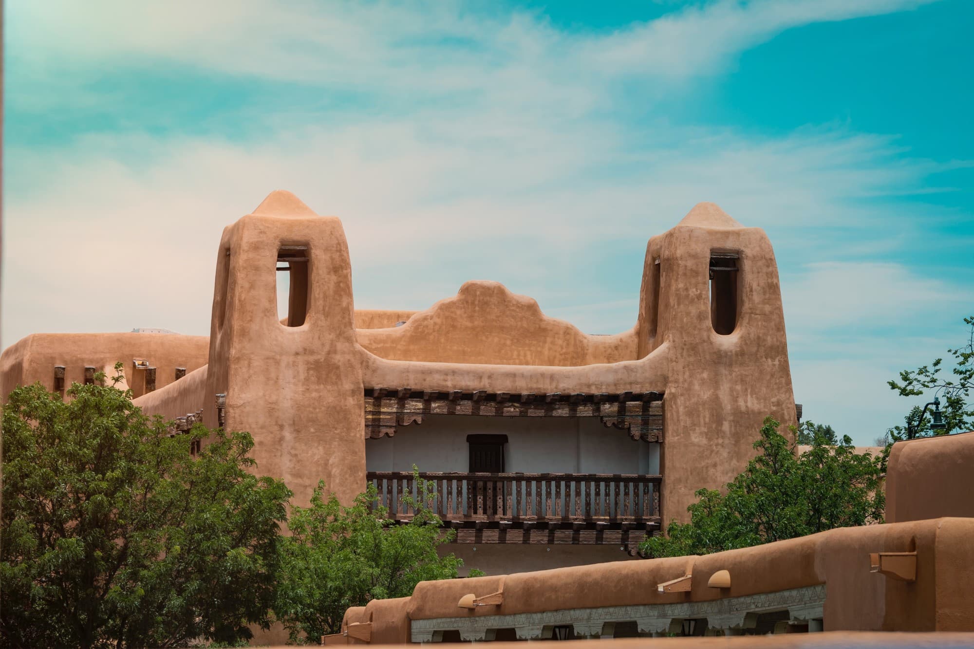 Southwestern adobe home set against a turquoise sky