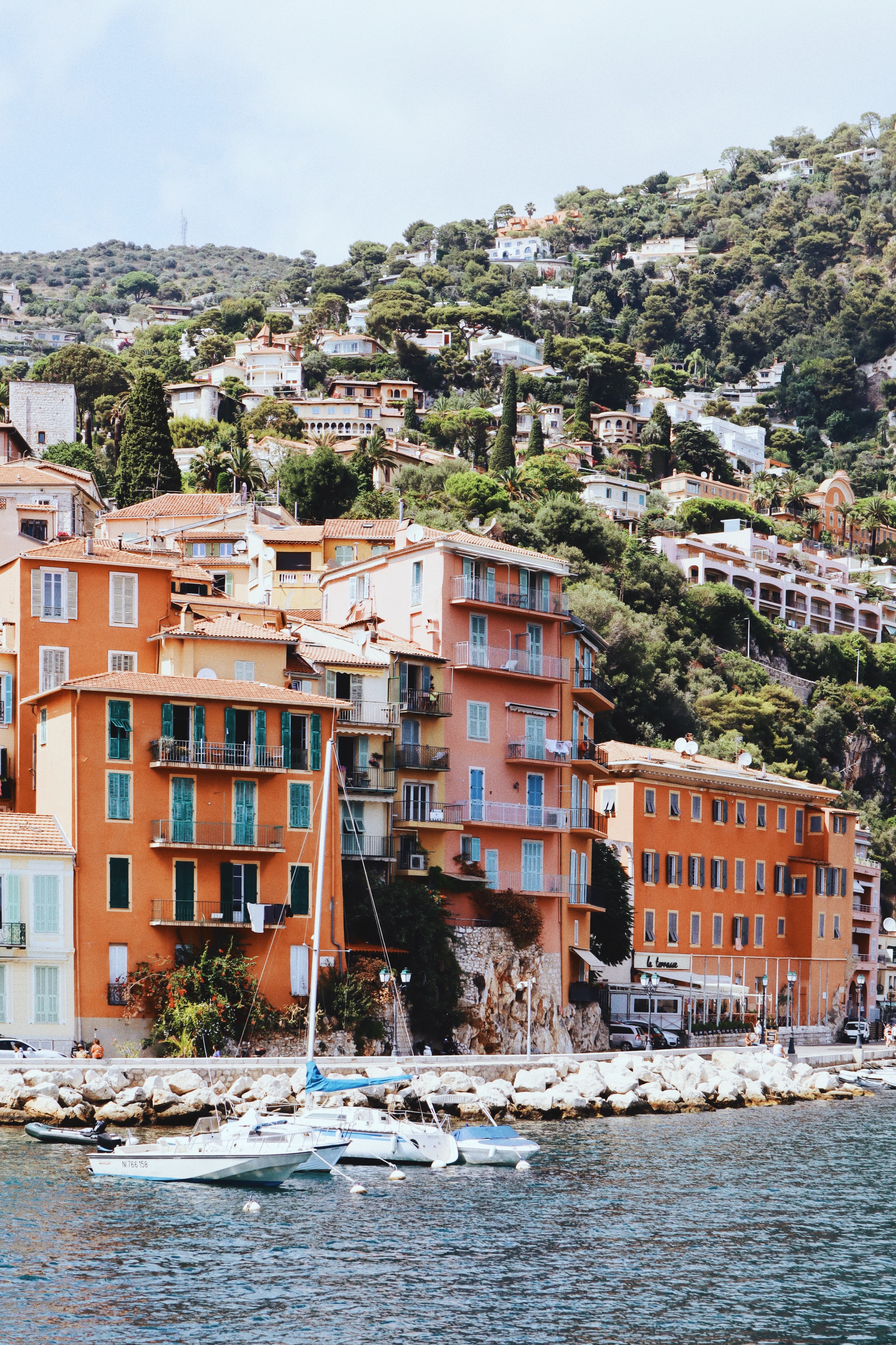 boats in body of water next to colorful building during daytime