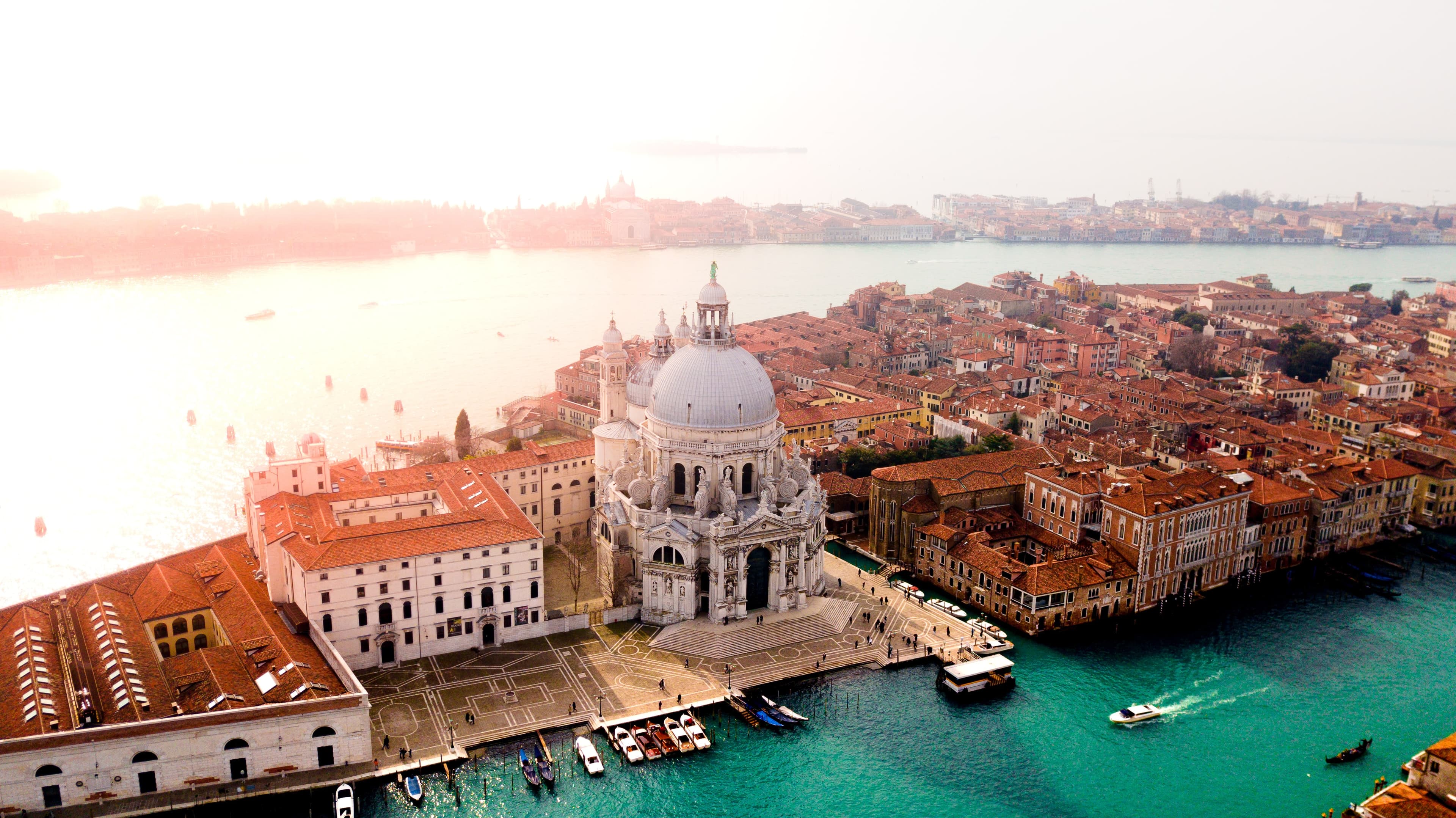 Venice Italy city birds eye view blue canal with boats and red buildings