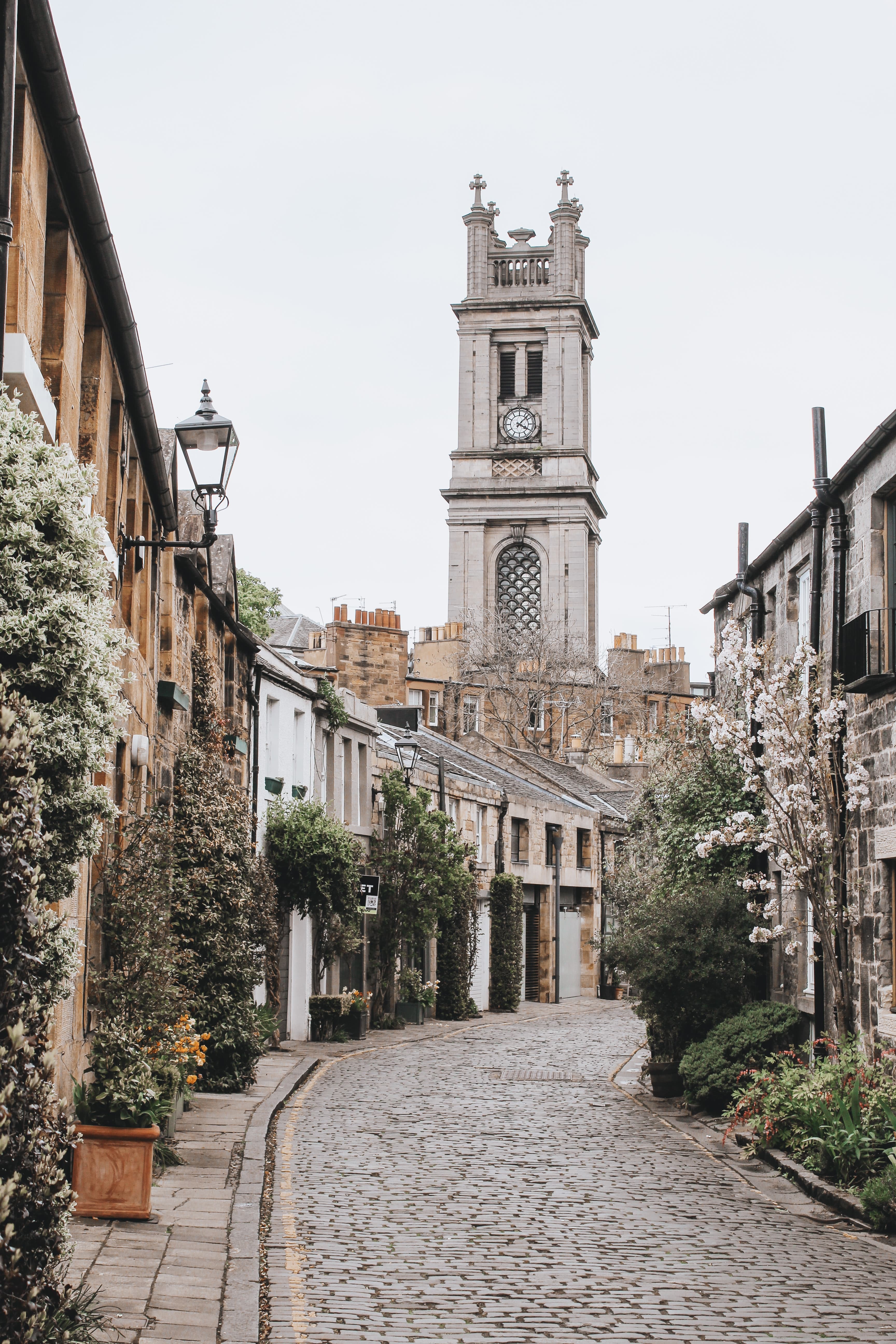 Cobblestone street leading to tower on a cloudy day