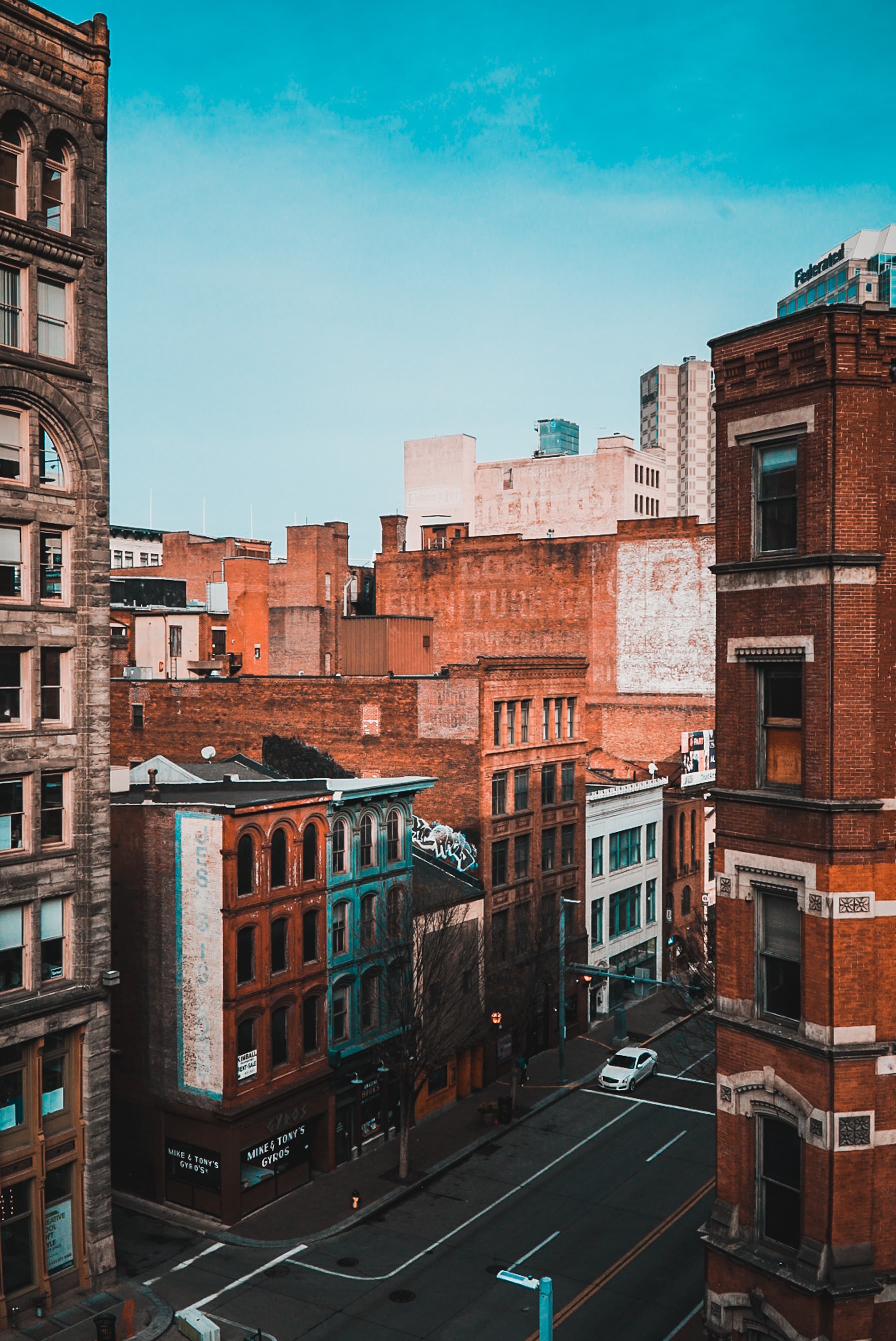 Orange and white buildings with the street and a blue sky