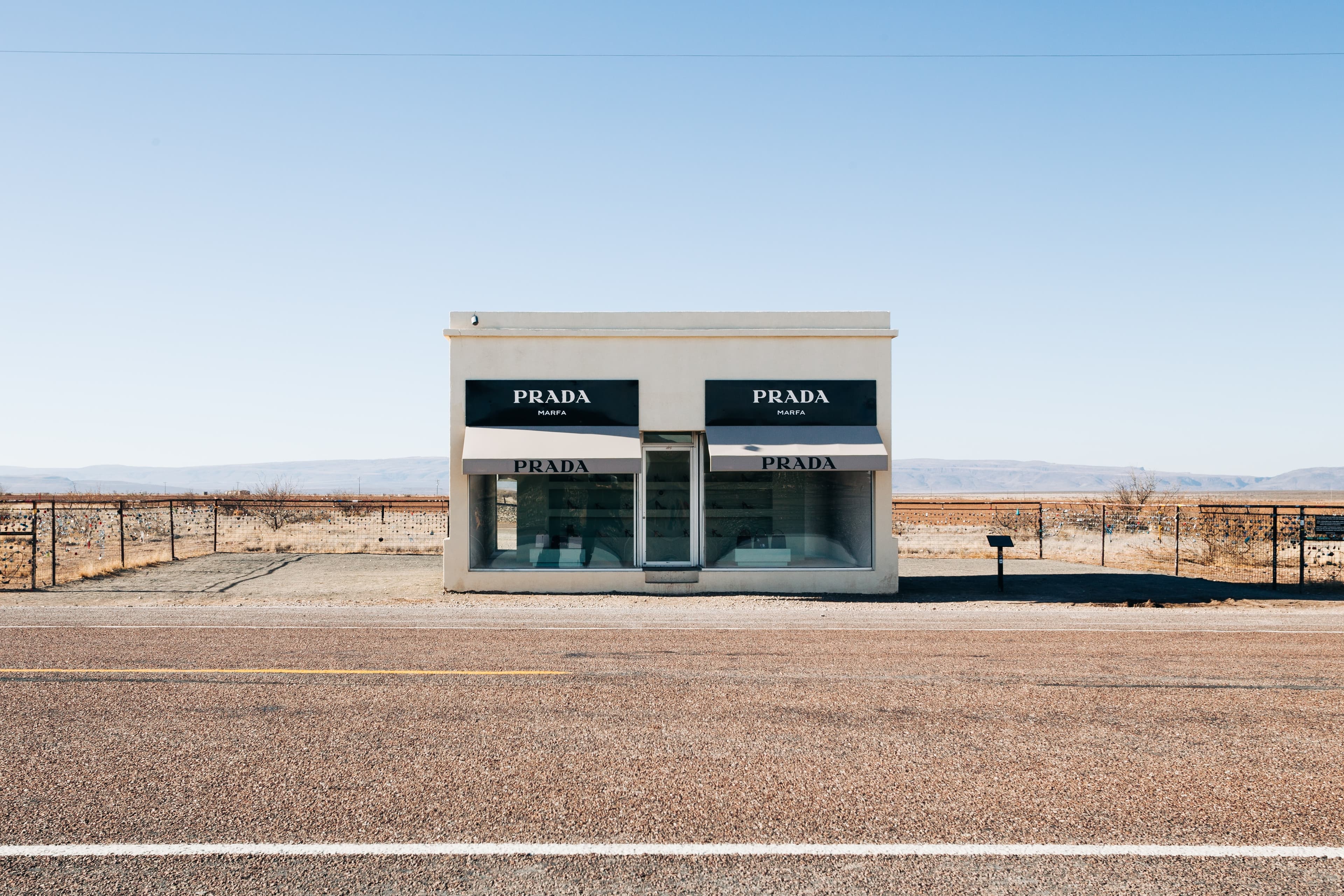 An art installation of a black and white abandoned Prada store on a side of a highway in west Texas.