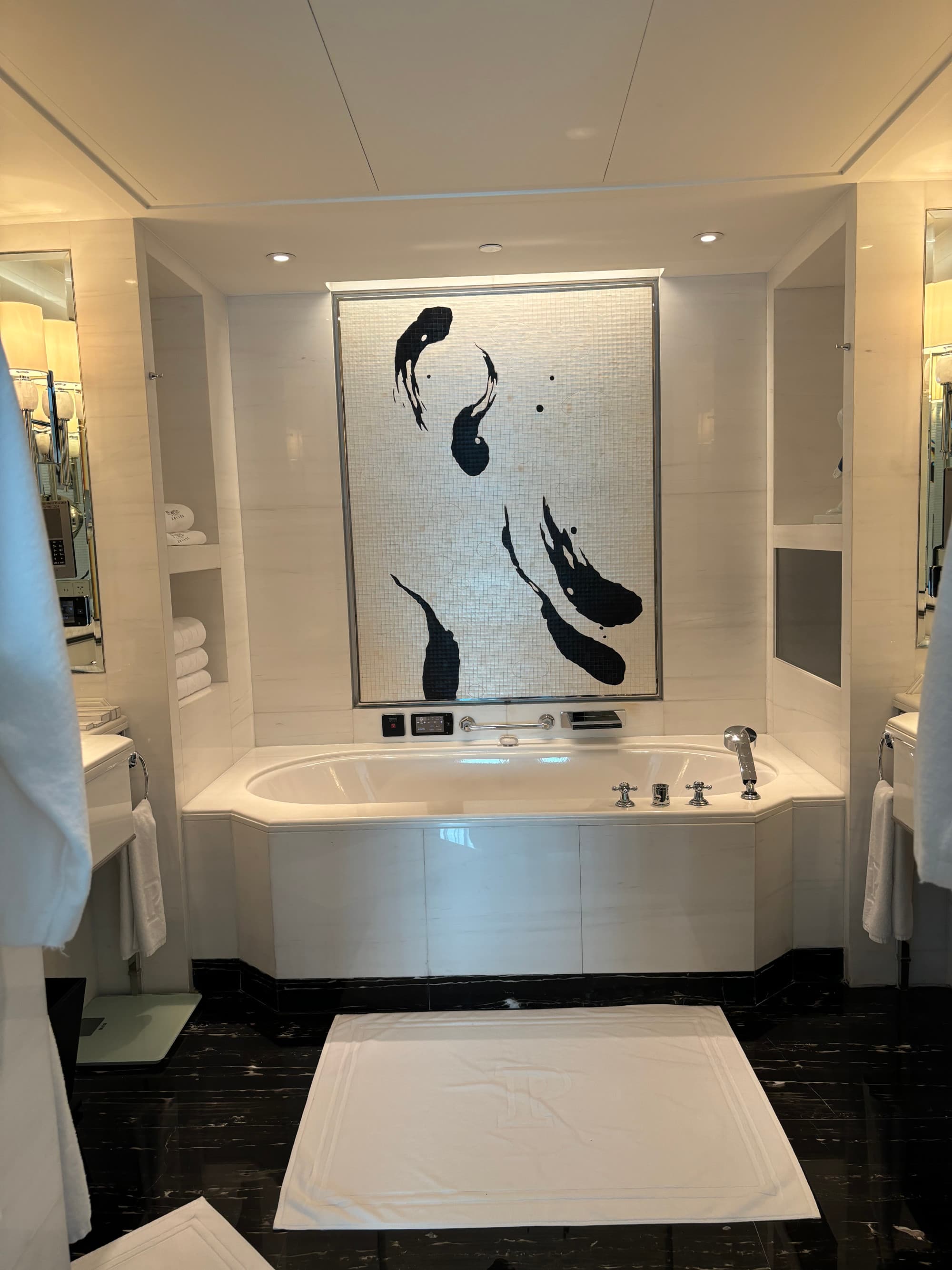 A bathroom with a large, white bathtub