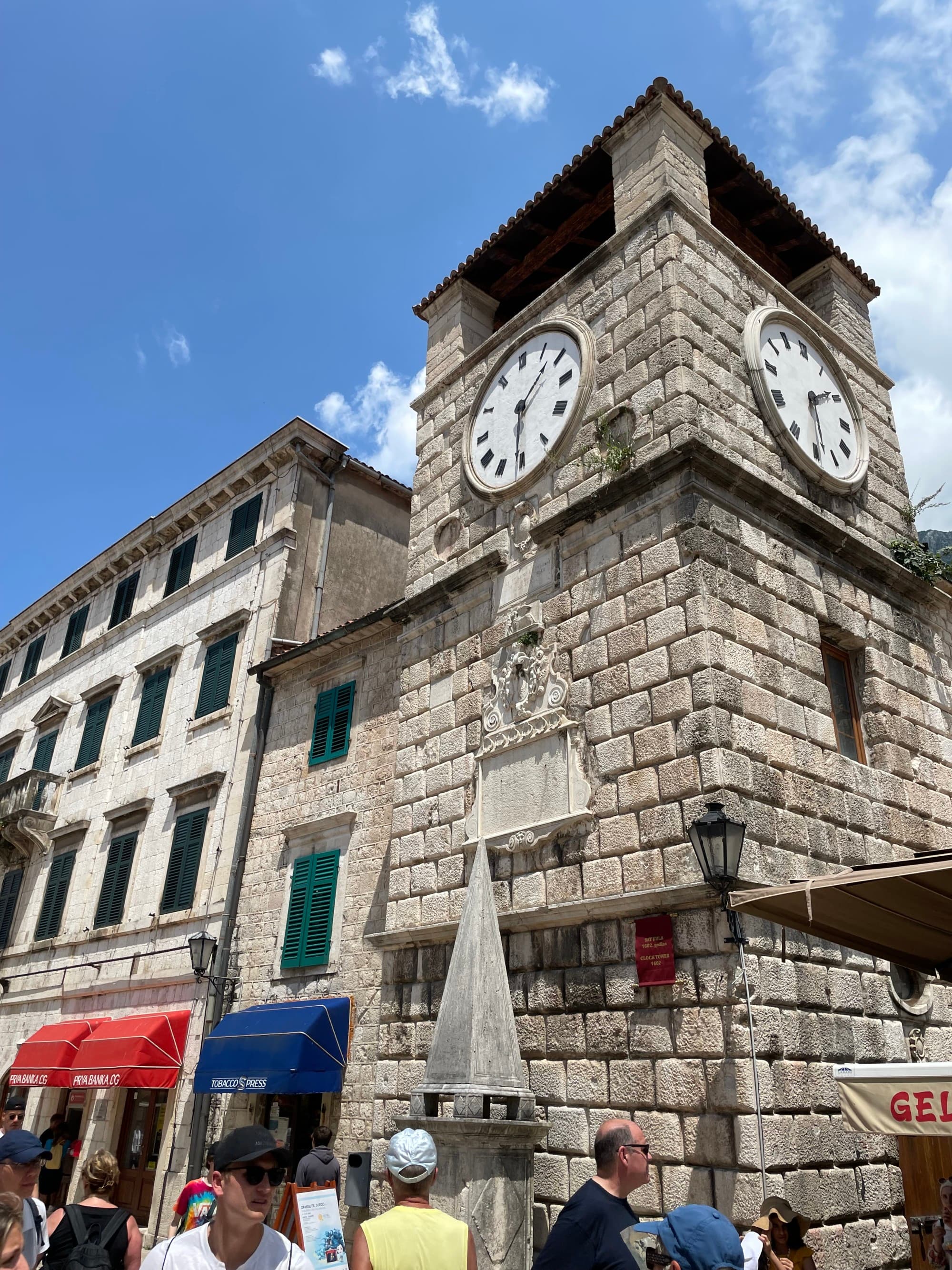 The outside of a brick clock tower during the daytime