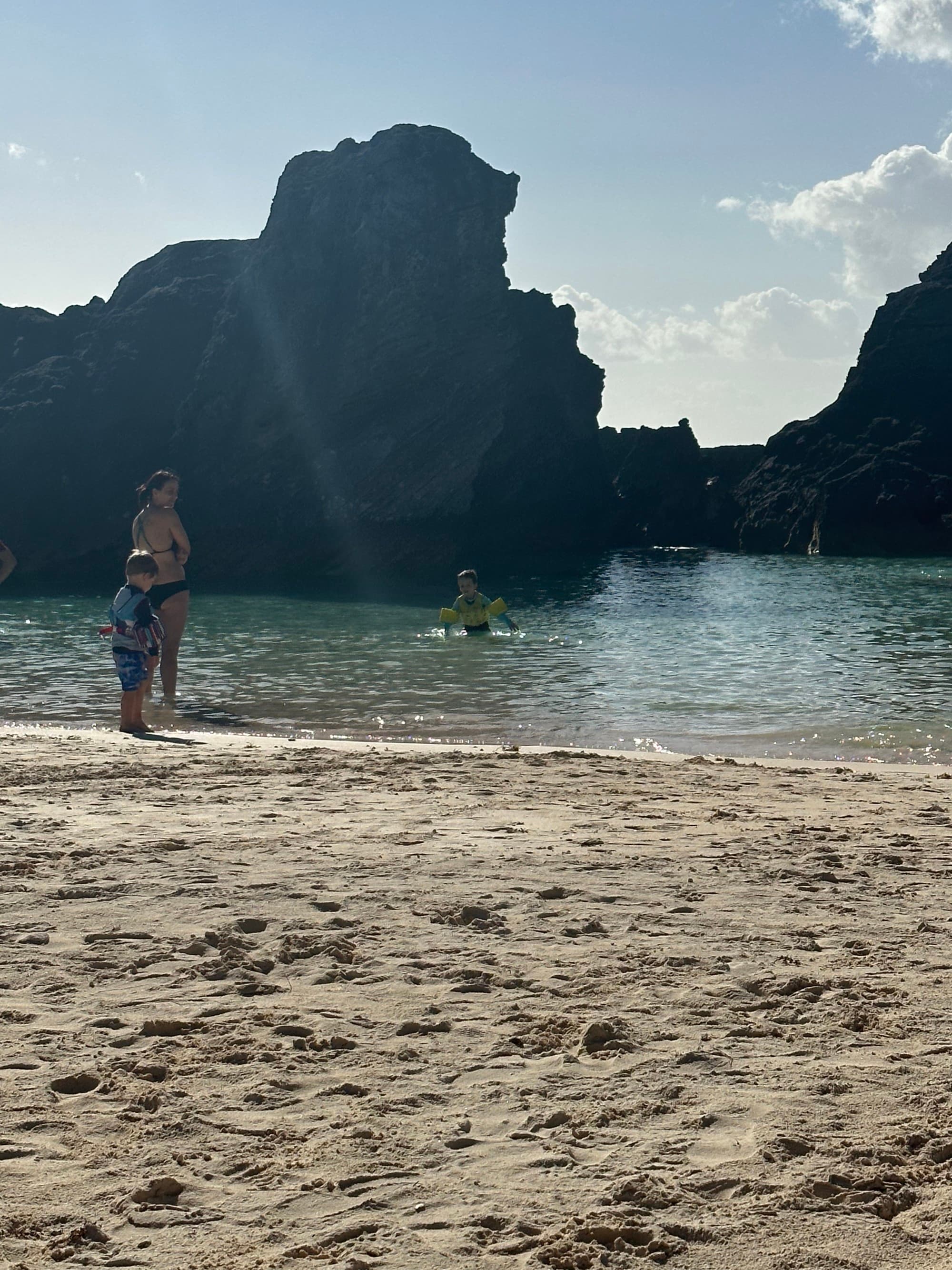 A picture of a person and a child at the beach at a wading area perfect for kids at Horseshoe Bay