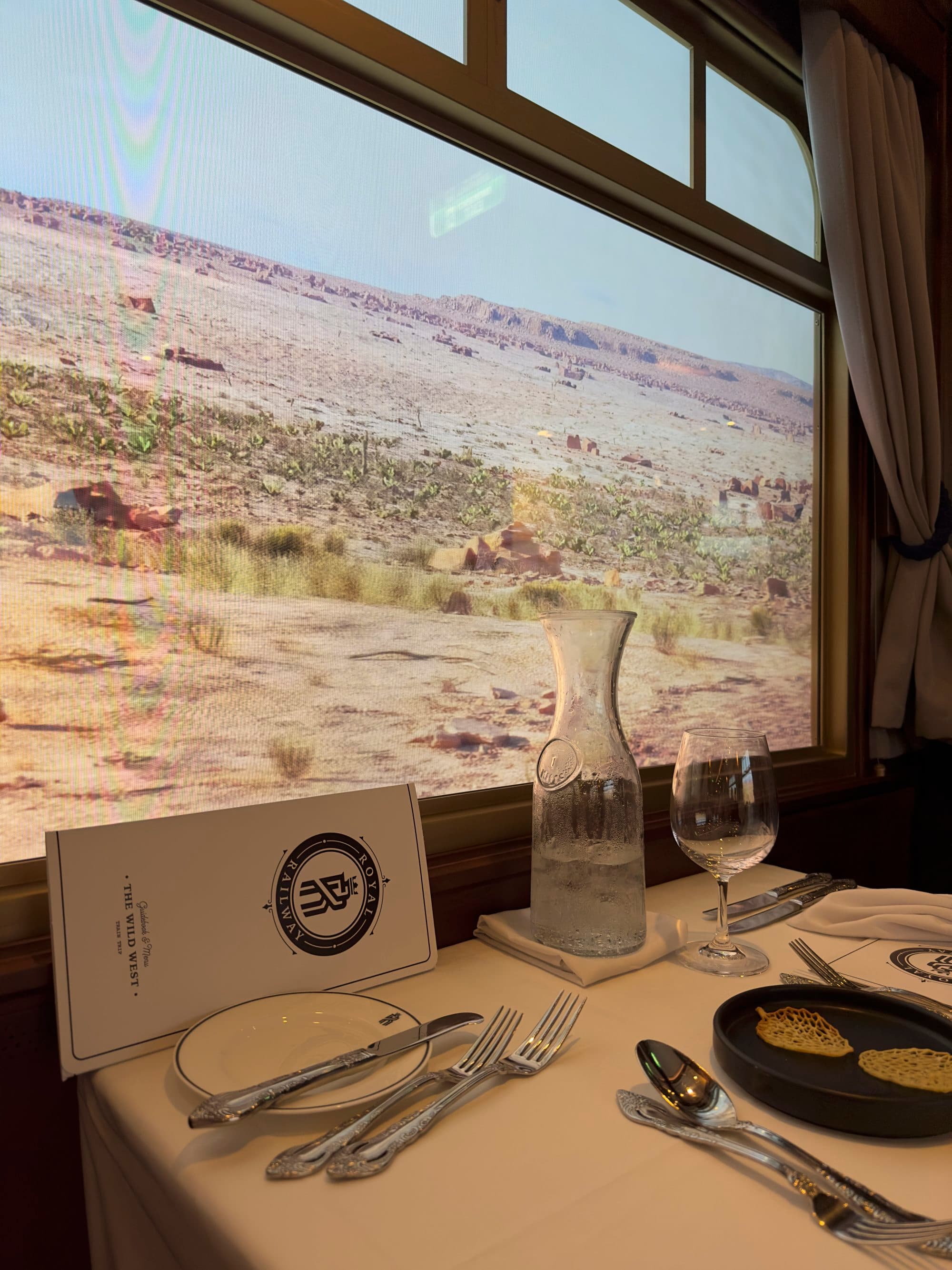 Utopia Station Specialty Dining Restaurant, looking at a picture of a desert scene in a Wild West themed restuarant.