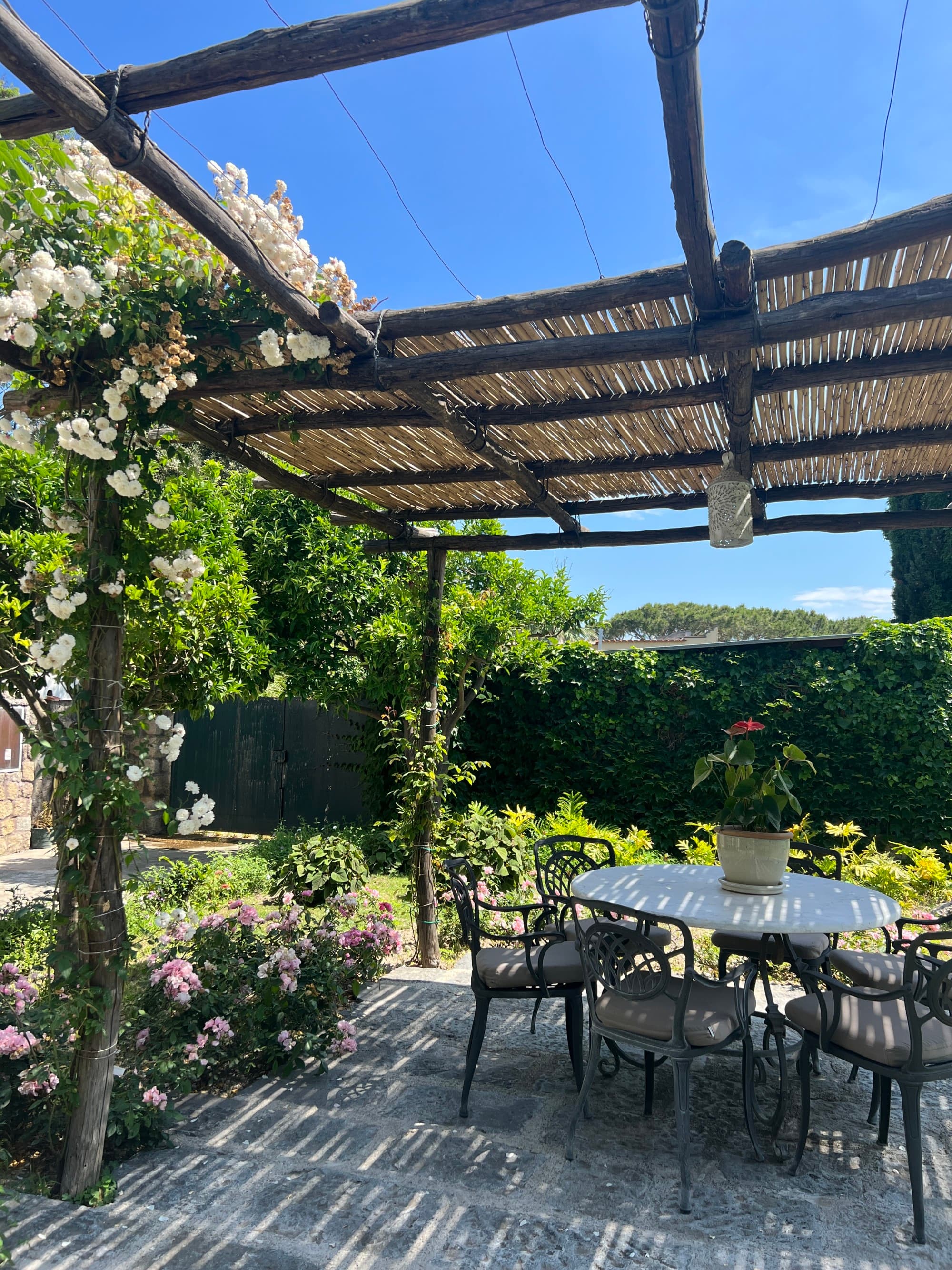 A small outdoor dining area under a wooden overhang