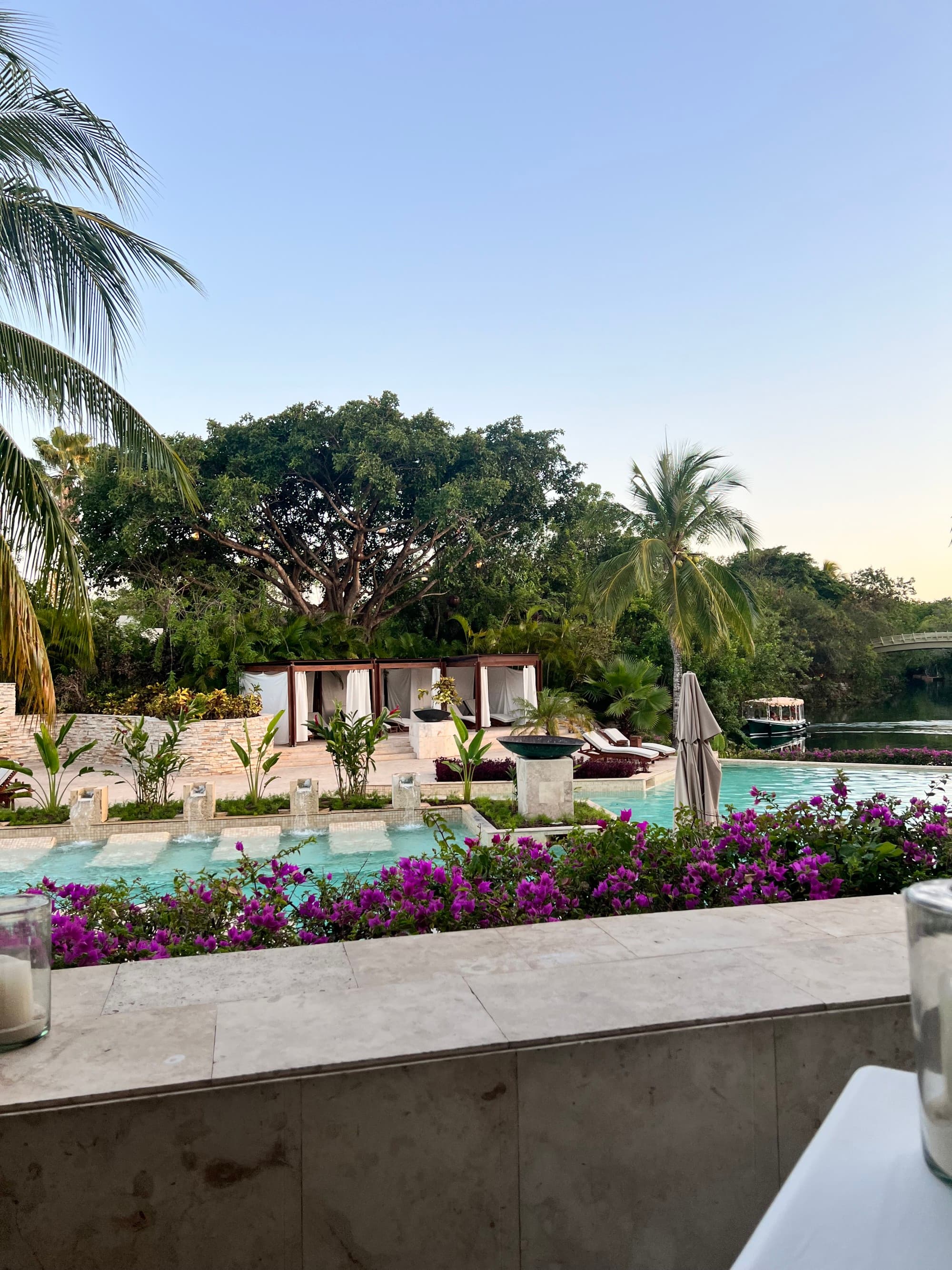 Rosewood during the day with palm trees and foliage in the distance.