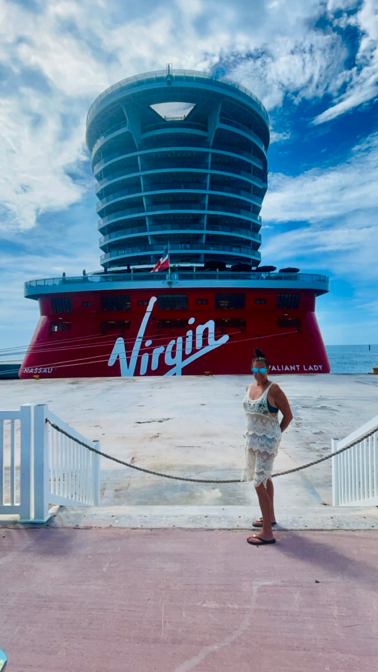 Travel advisor posing in front of a cruise ship.