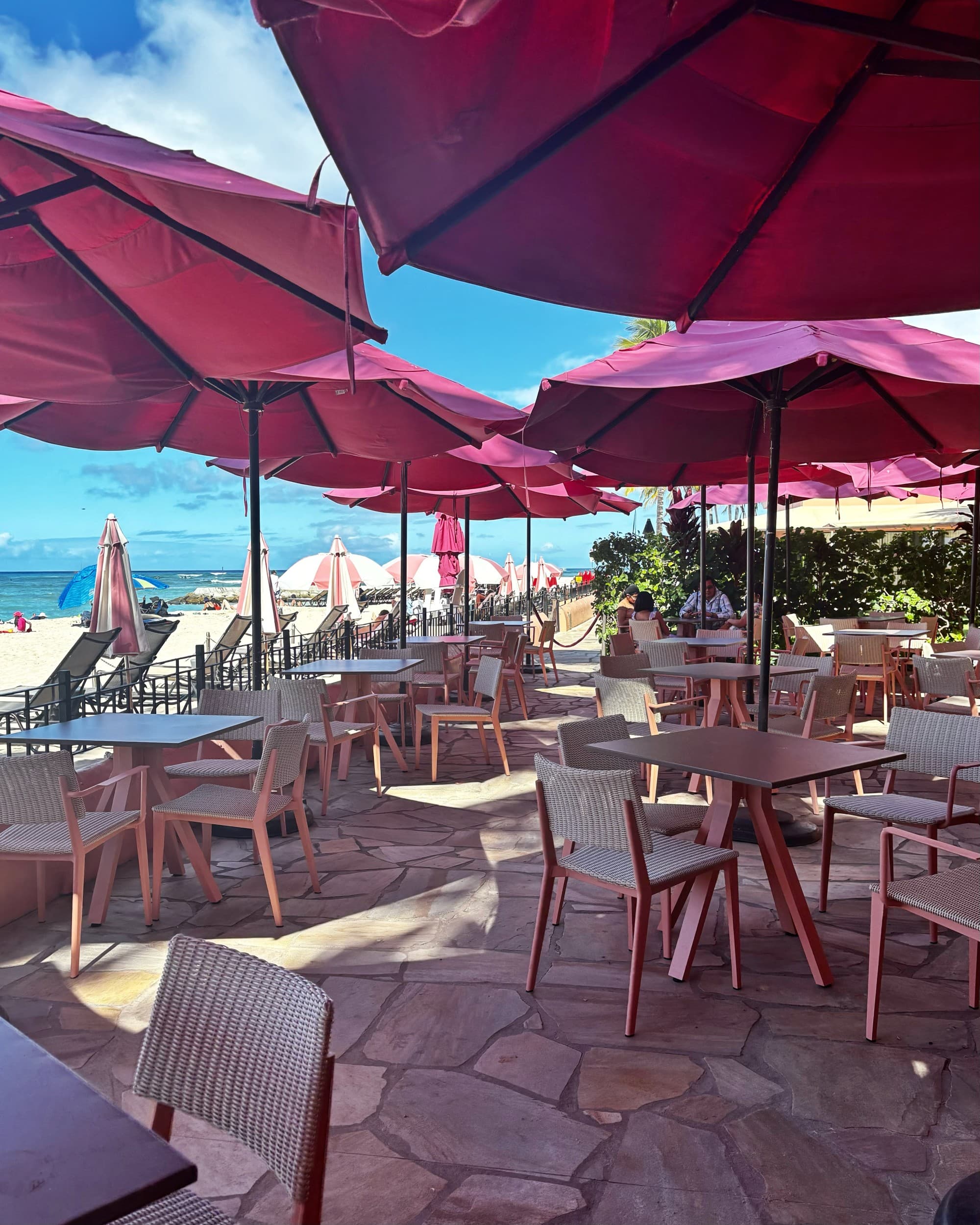 Patio bar with pink shade umbrellas.