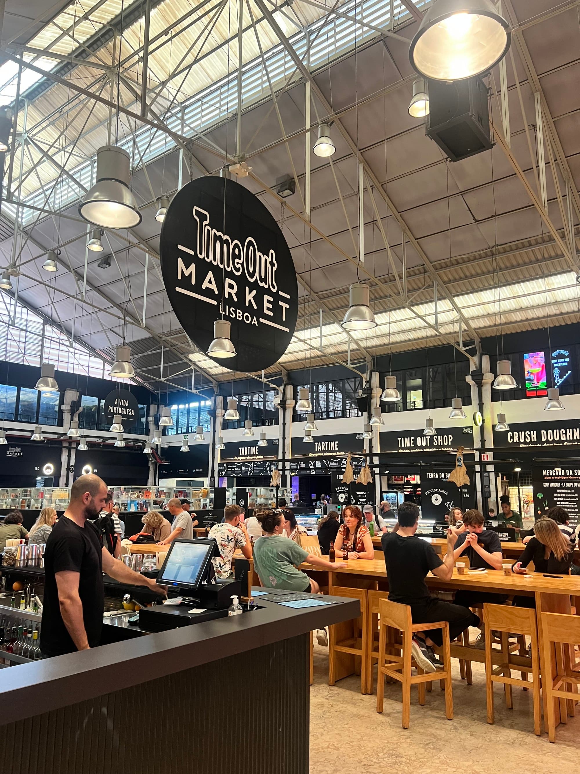 Time Out Market with high-top tables and a cash register.