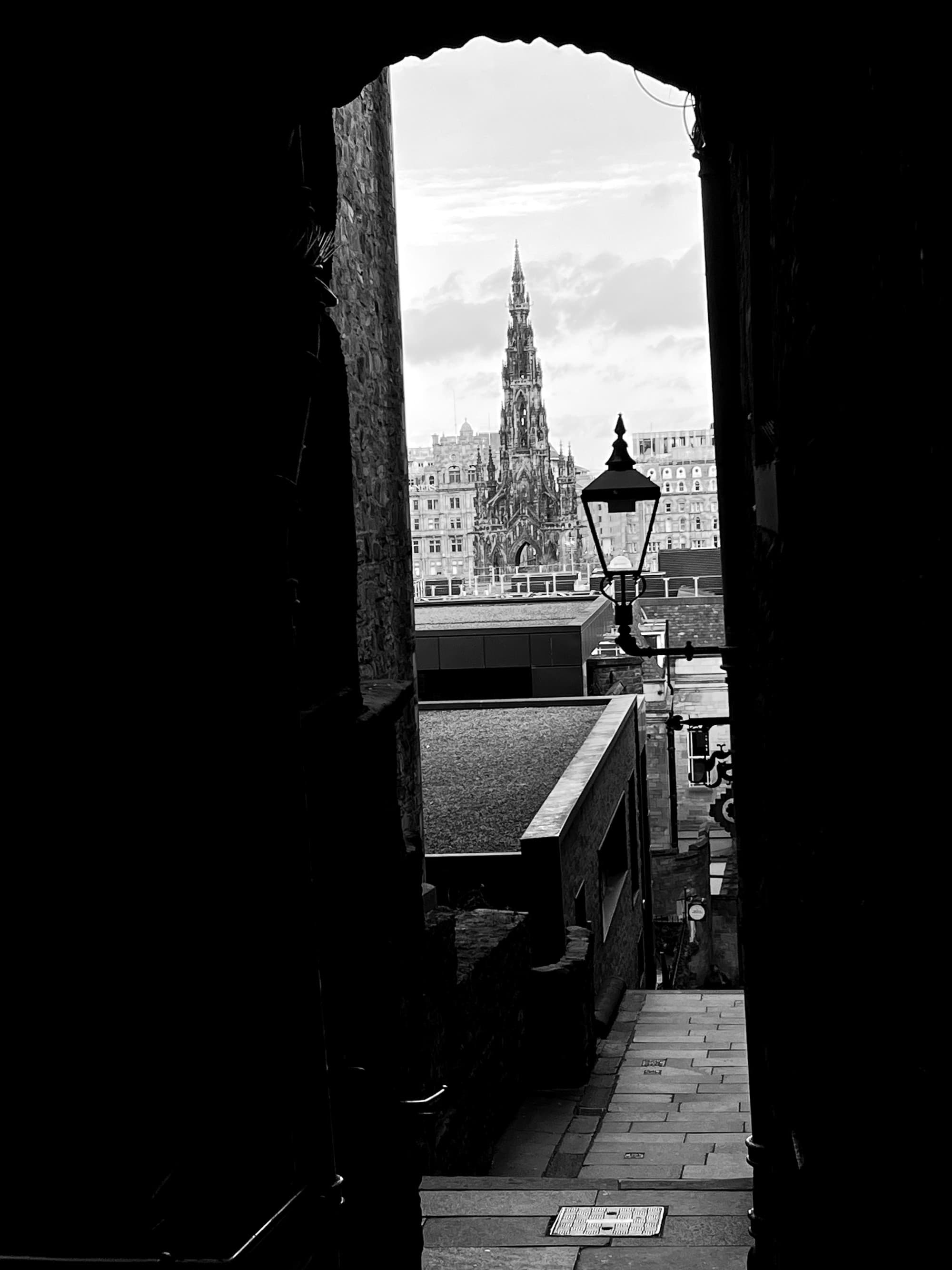 A view through a doorway overlooking tall spires reaching toward the sky on a hazy day.