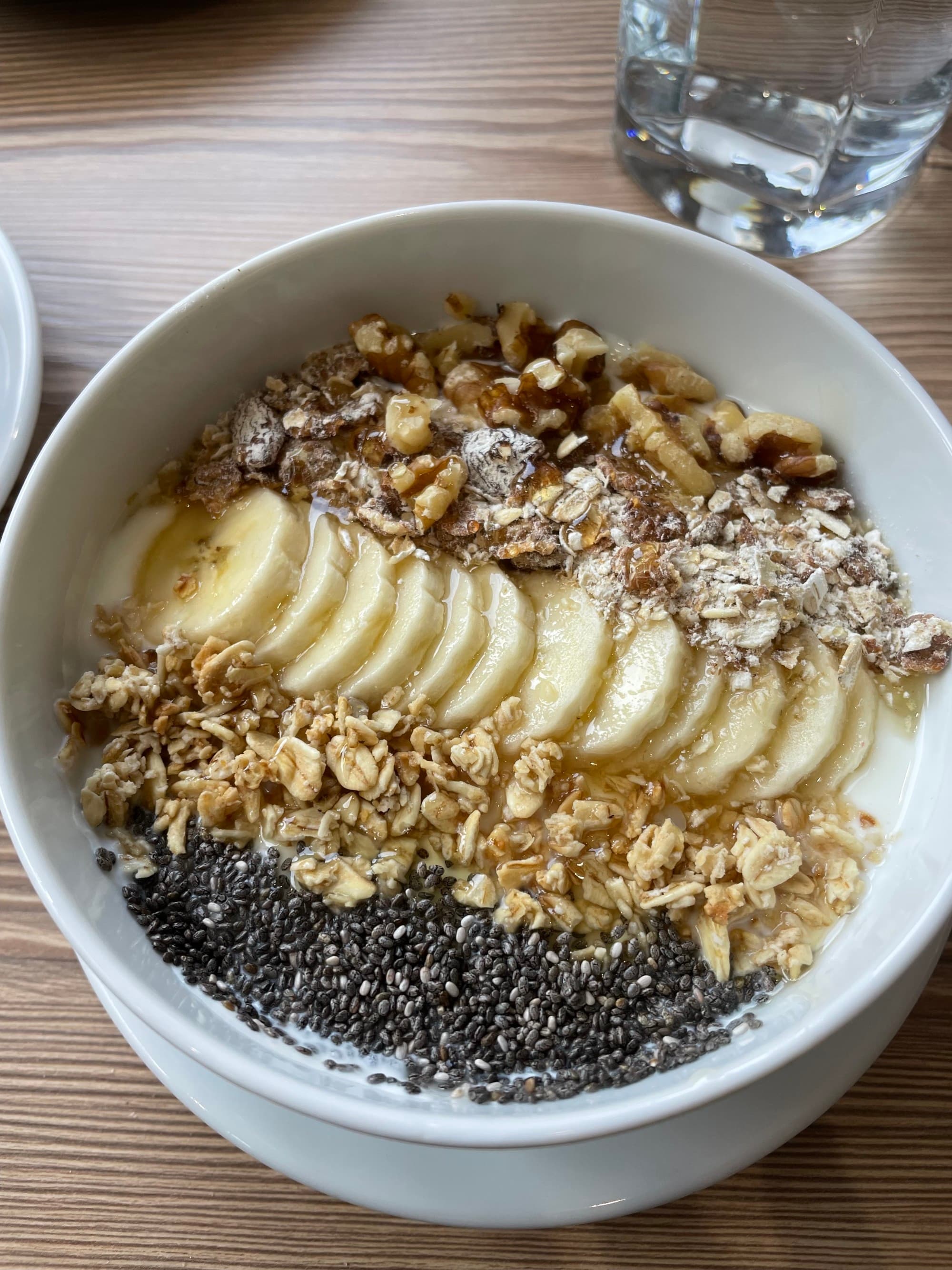 Breakfast Bowl with oats, nuts and sliced bananas at a Cafe in Edinburgh.