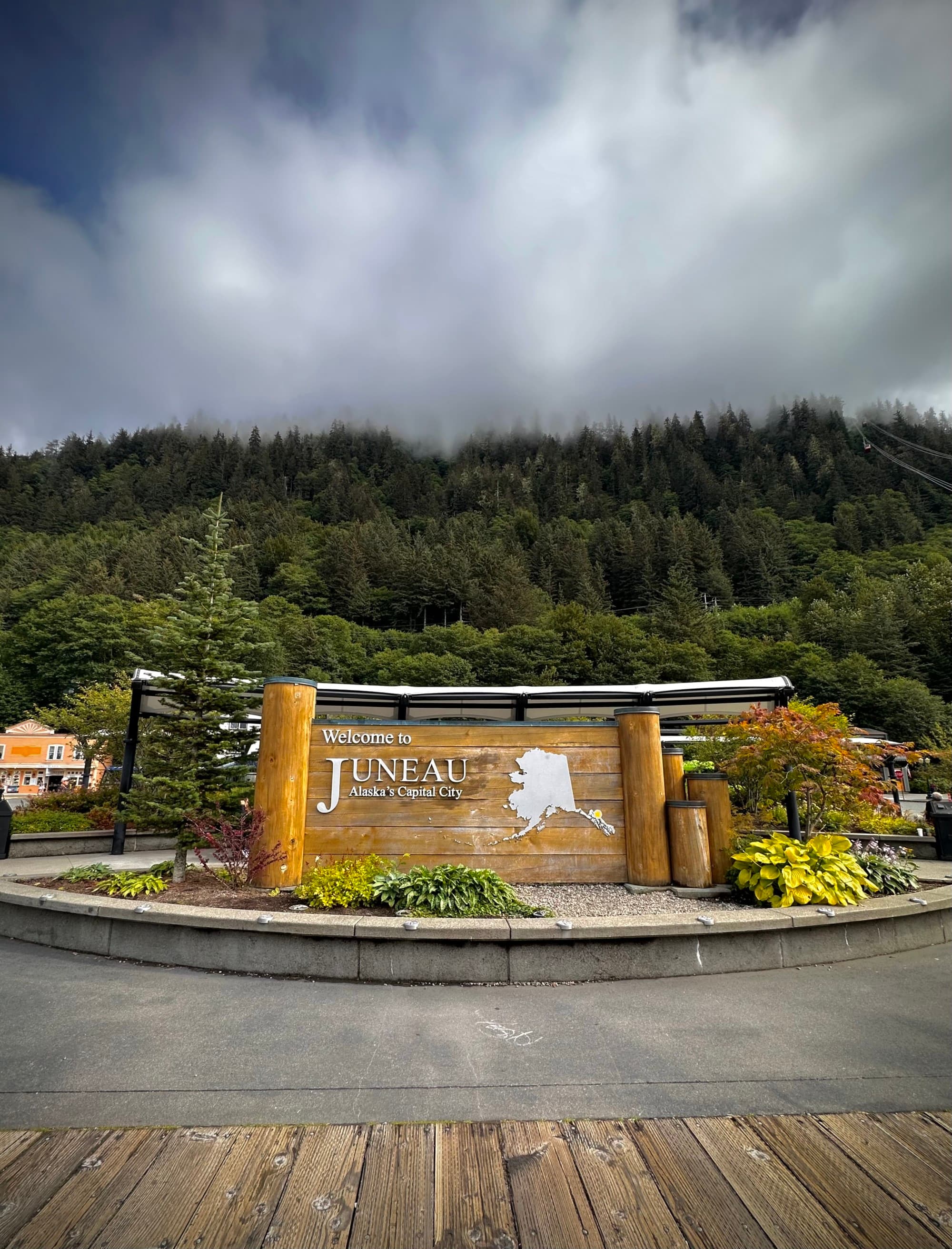 Juneau Alaska Port sign with trees in the background.