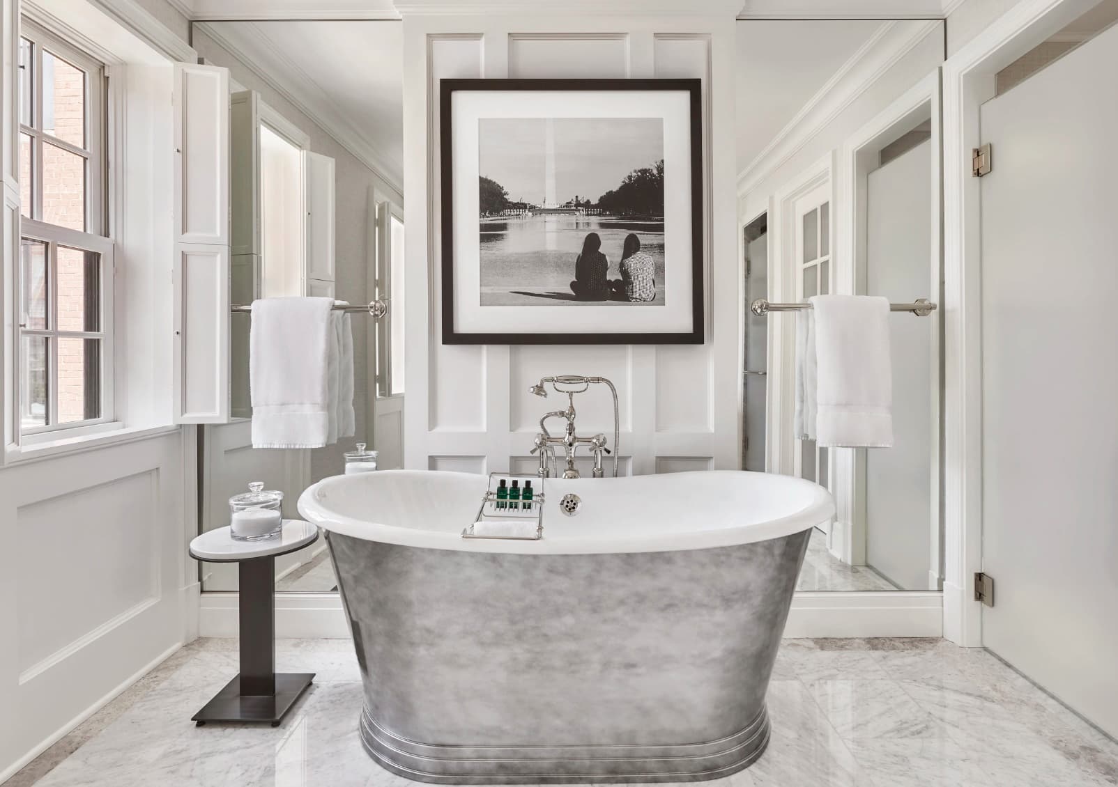 silver tub in a fancy white bathroom