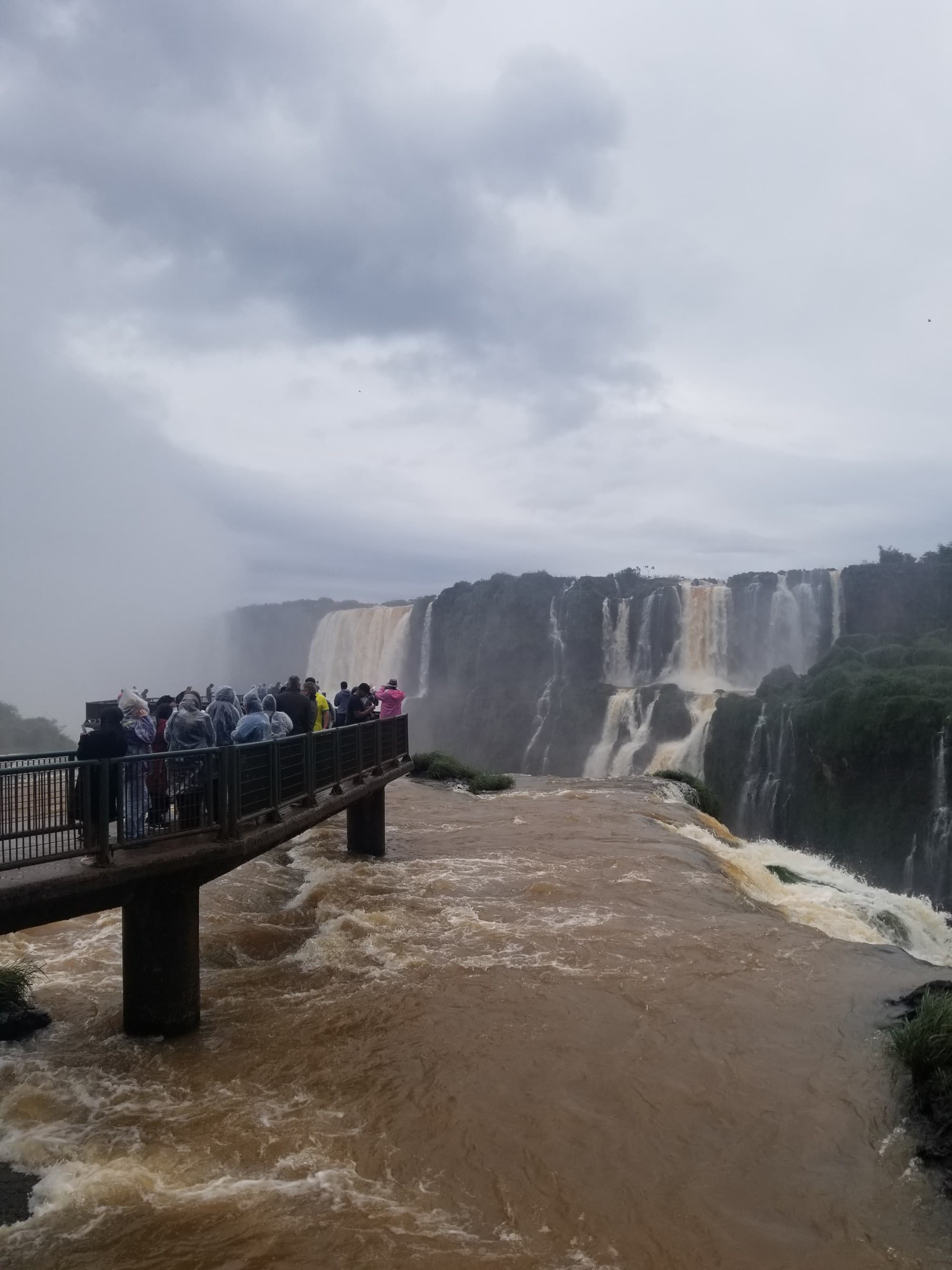 View of the waterfall area with people standing on an overlook