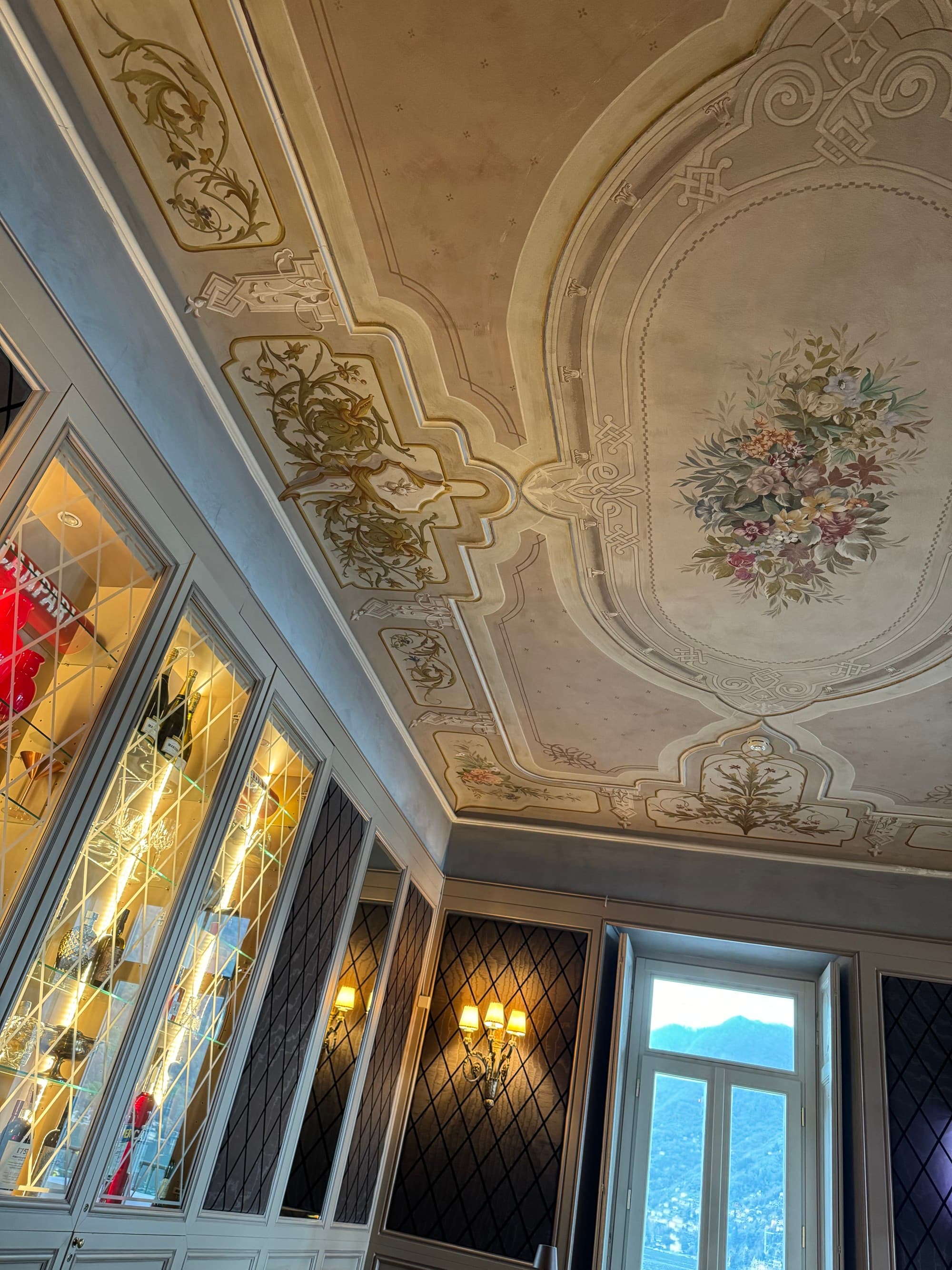 A photo of an intricately painted pastel and gray floral ceiling.