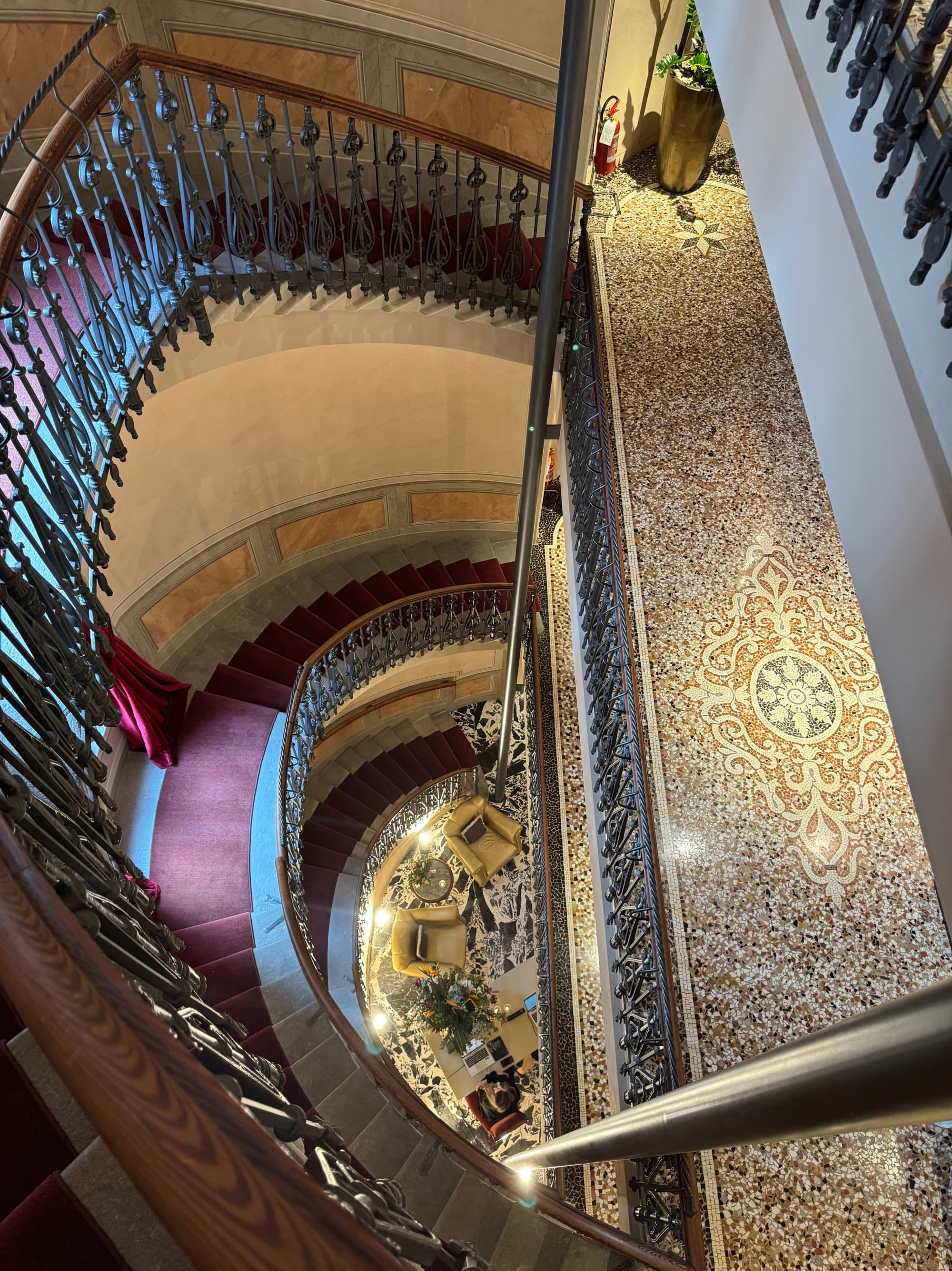 Aerial photo of an ornate spiral staircase leading through the hotel.