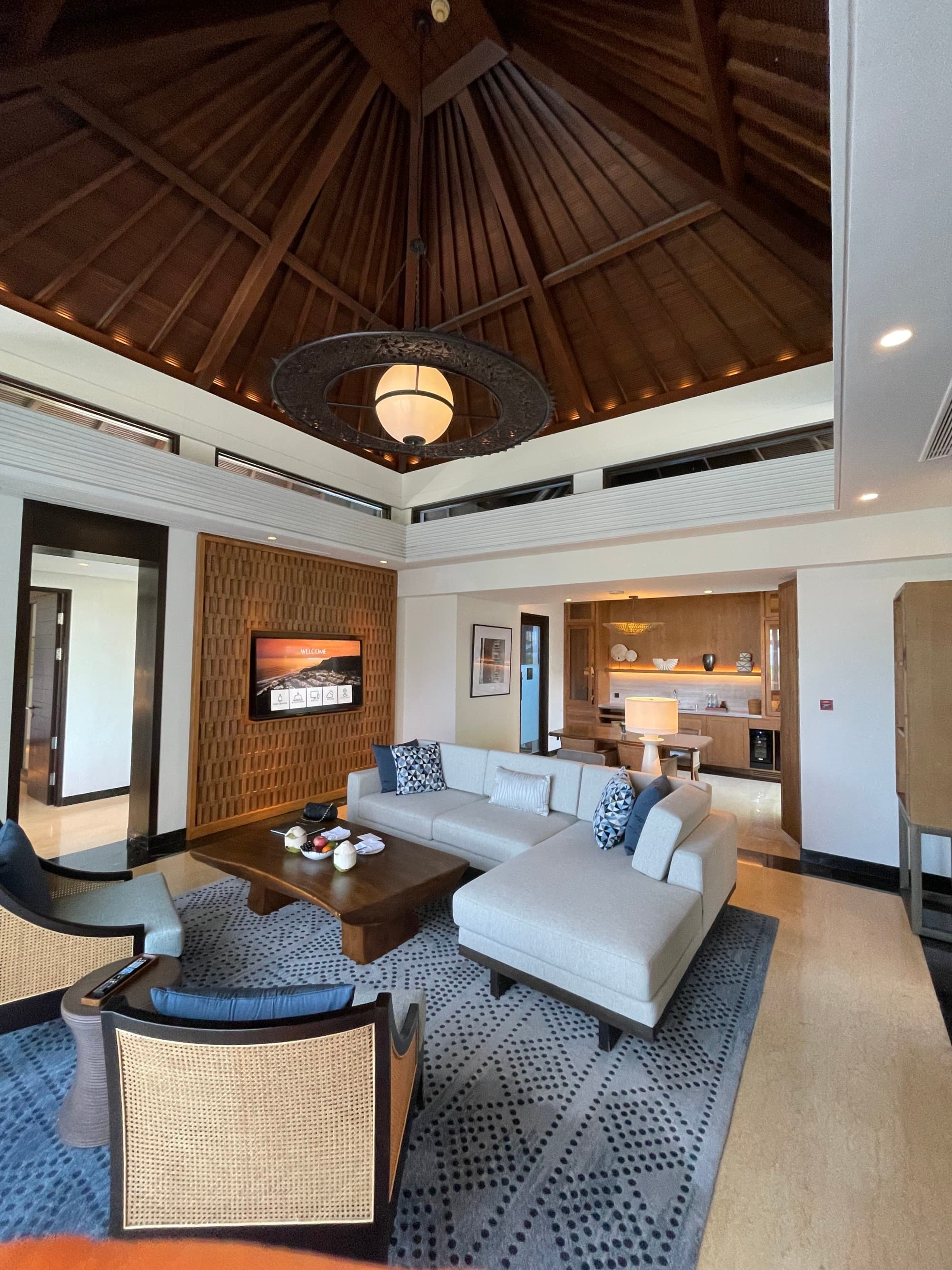 A villa living room with a white couch in the middle