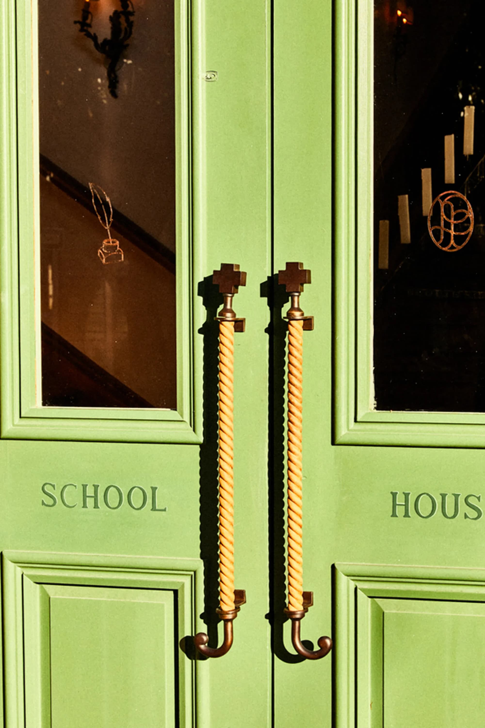 An original front, lime-green, door with "School House" written on it.