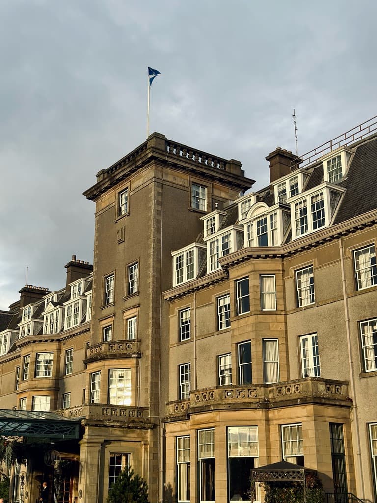 The Gleneagles Hotel with a lot of windows and the skyline in the distance.