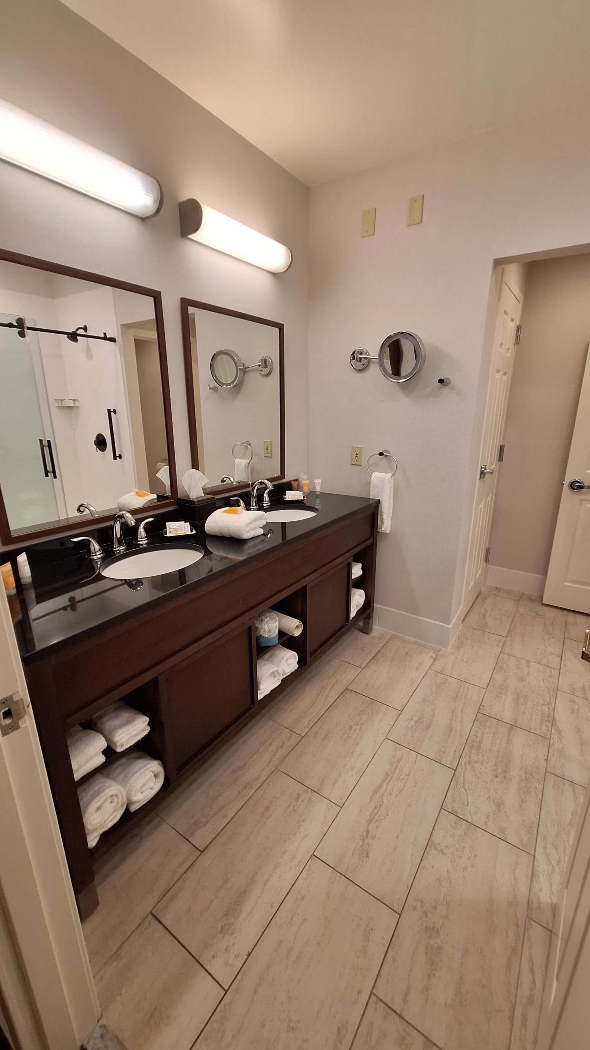 A photo of a bathroom with double sinks and mirrors