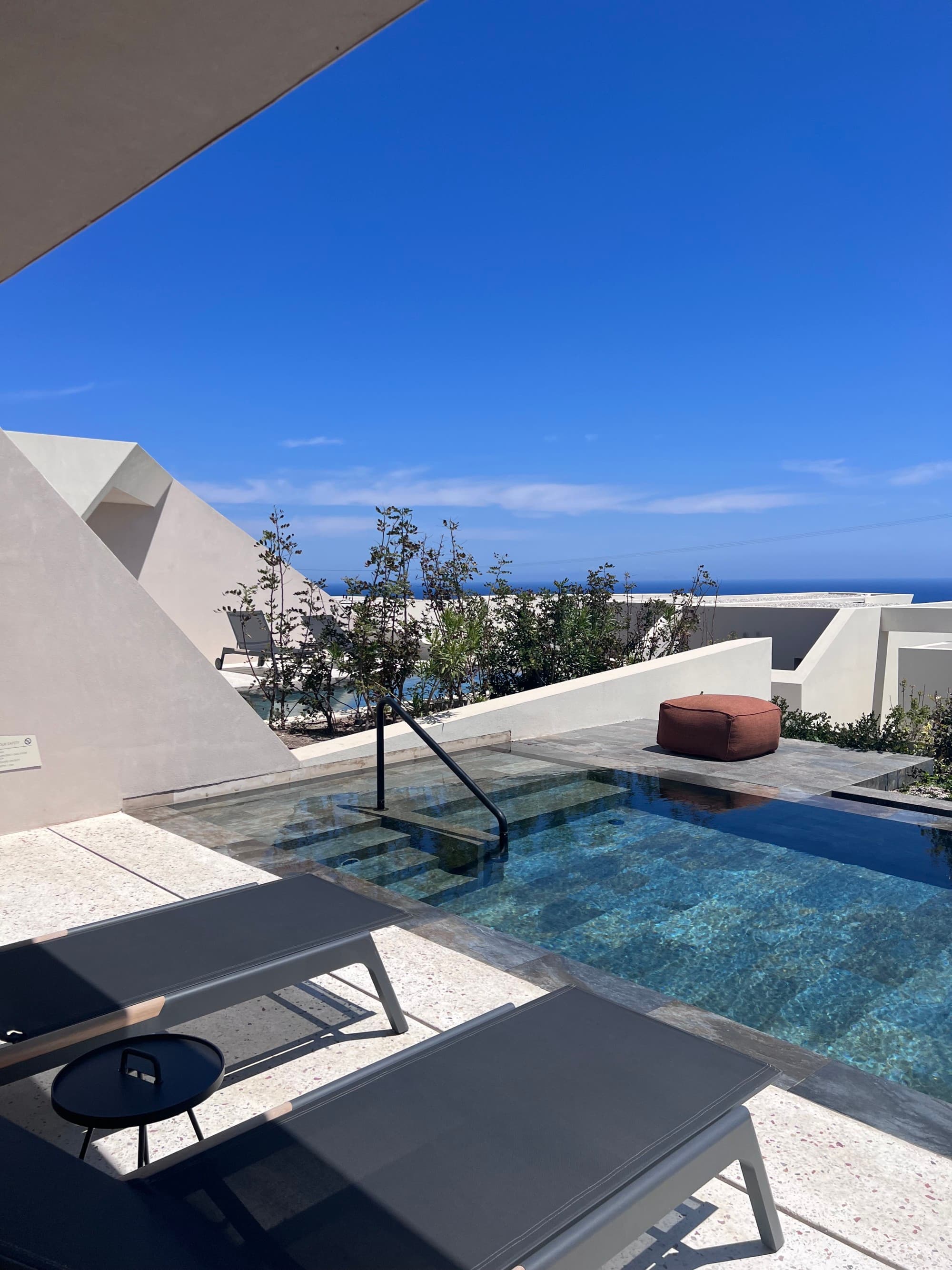 lounge chairs beside a terrace infinity pool