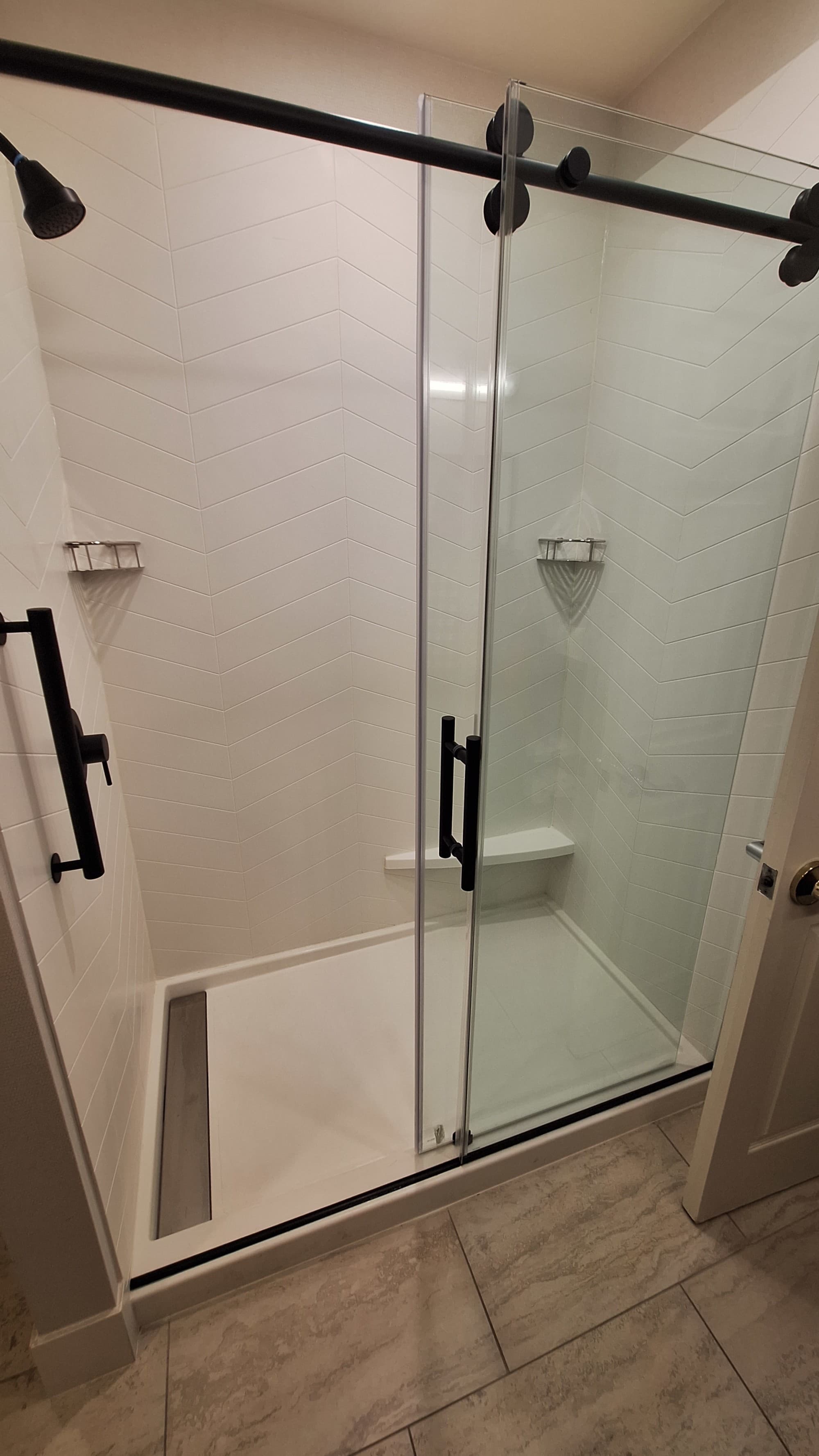 A photo of a shower with a glass door