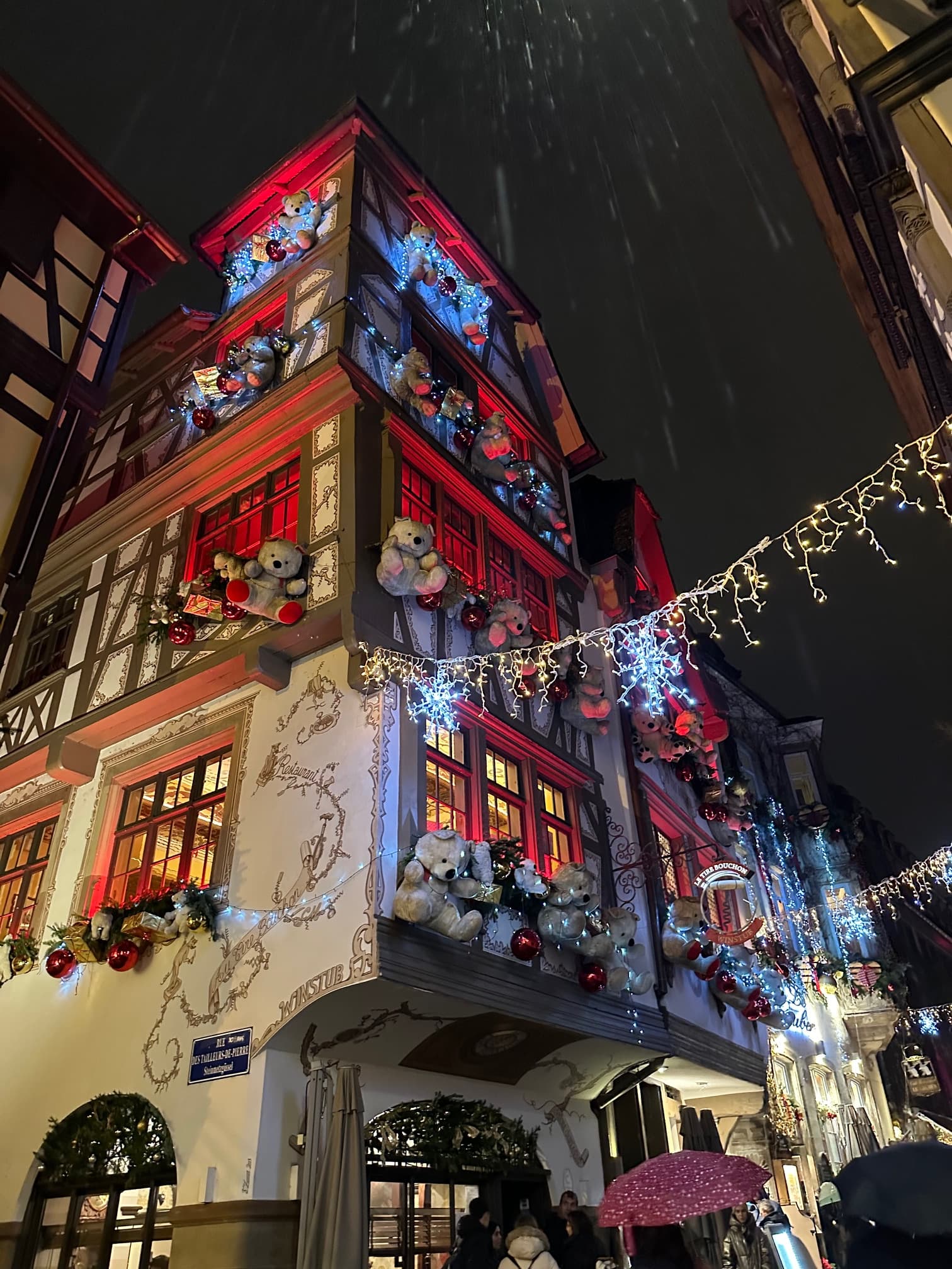 Christmas decorations around a tall, red building