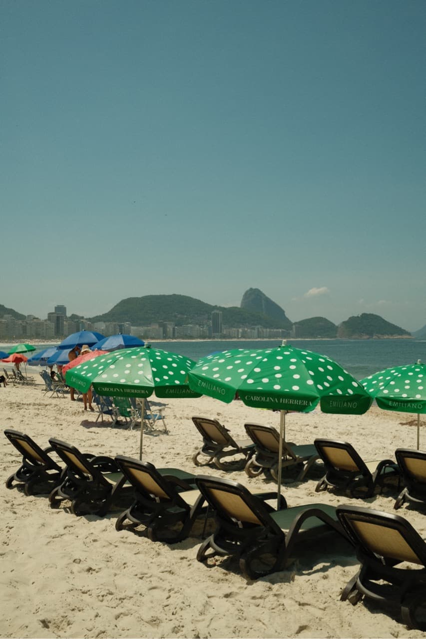 Sea and seaside view with beach loungers and sun umbrellas.