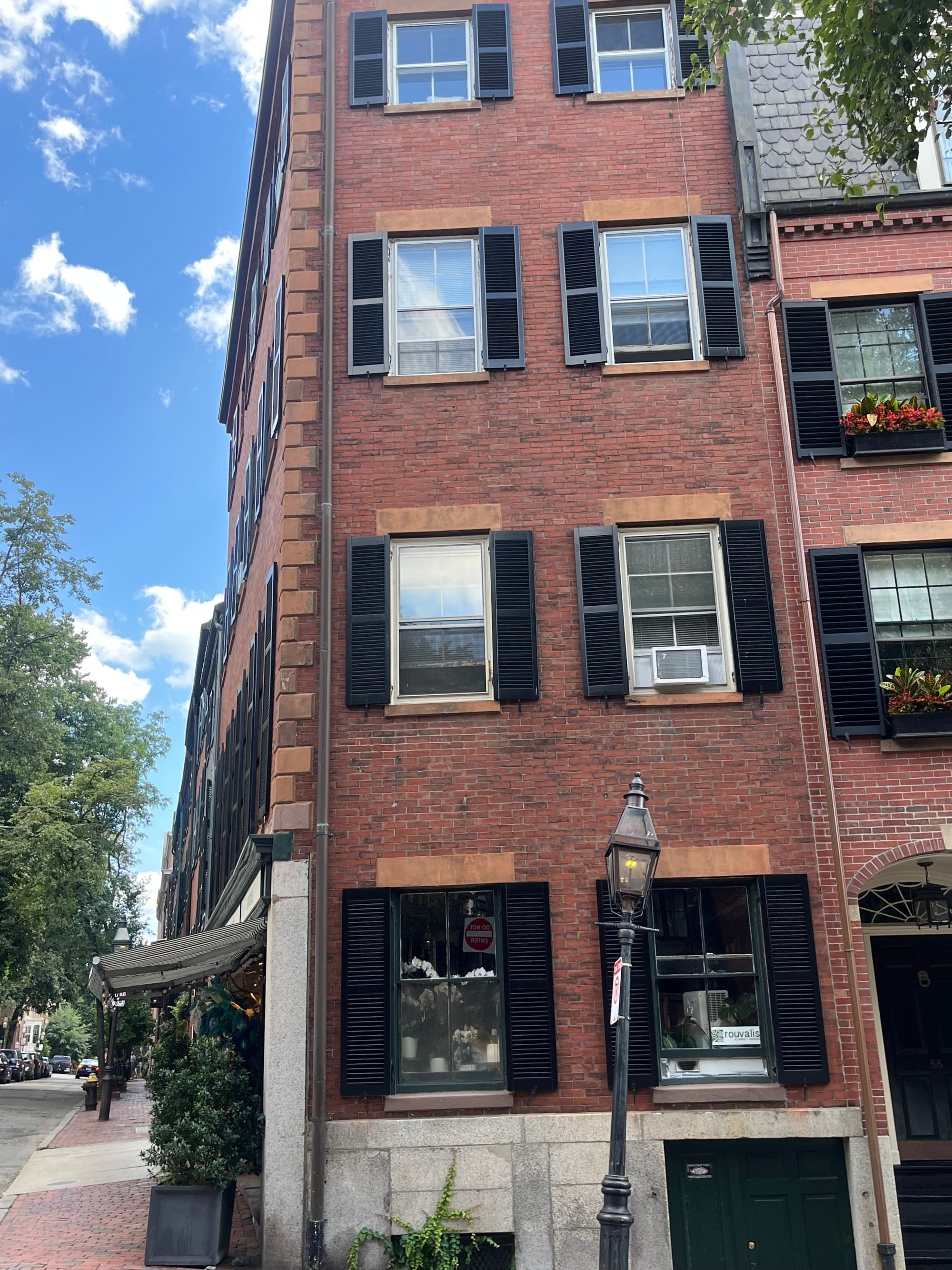 A red brick building on a street in Boston