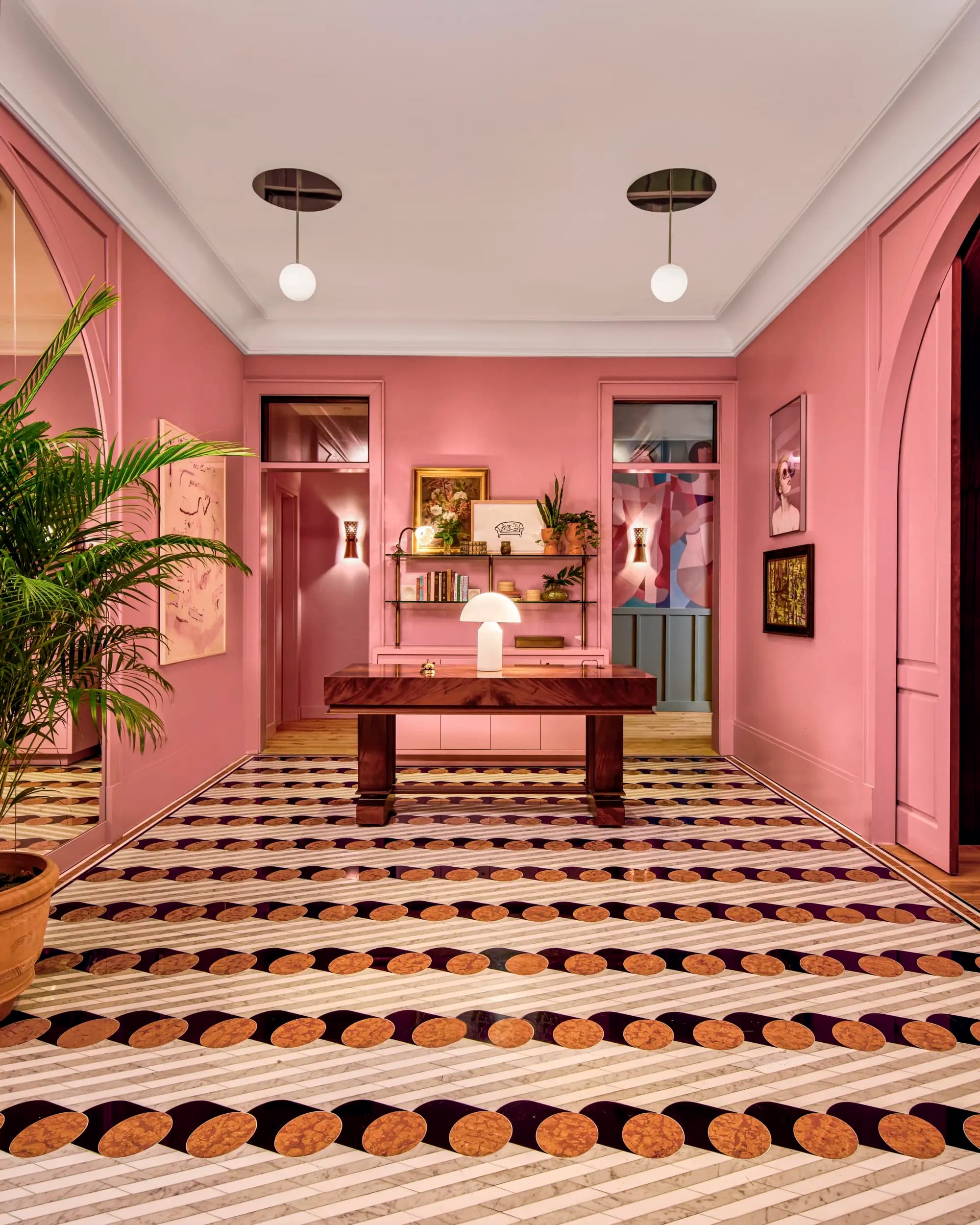 a vibrant pink lobby with patterned carpet