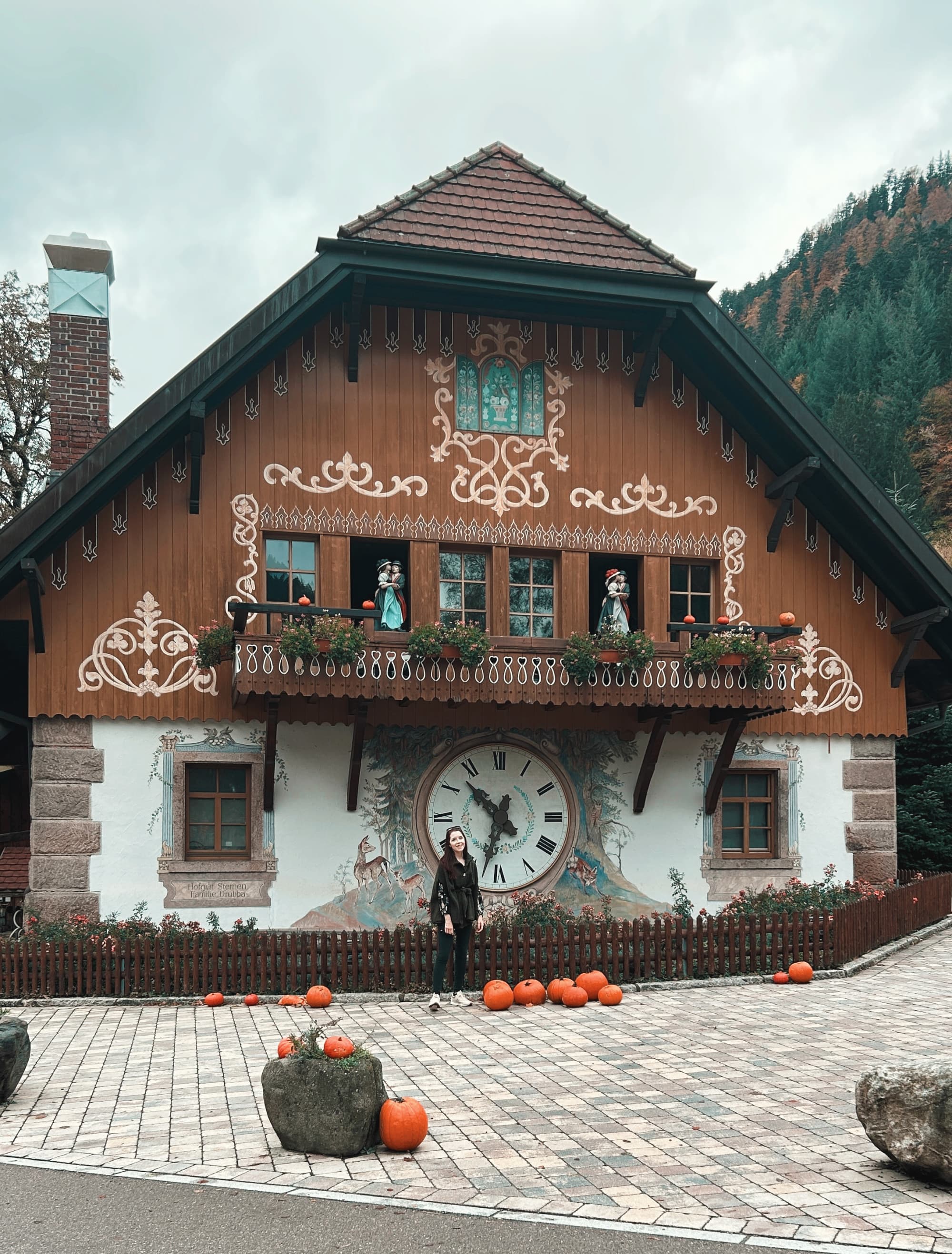 Travel advisor posing in front of a hut