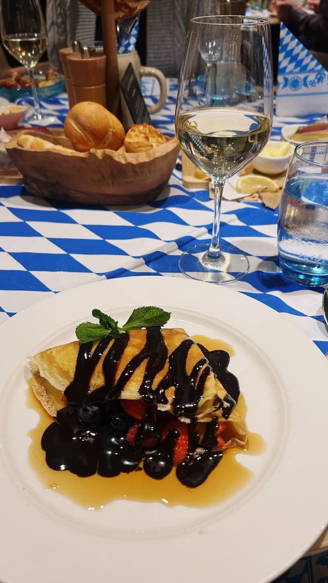 Food on a white plate sitting on a checkered blue and white table cloth