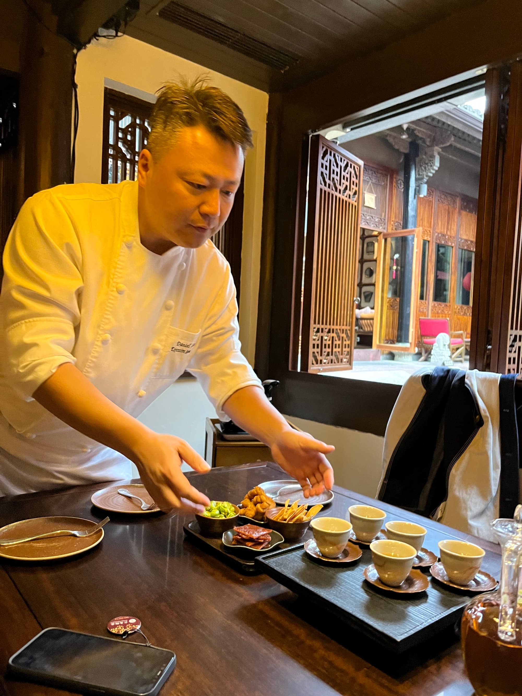 A chef plating food on a table