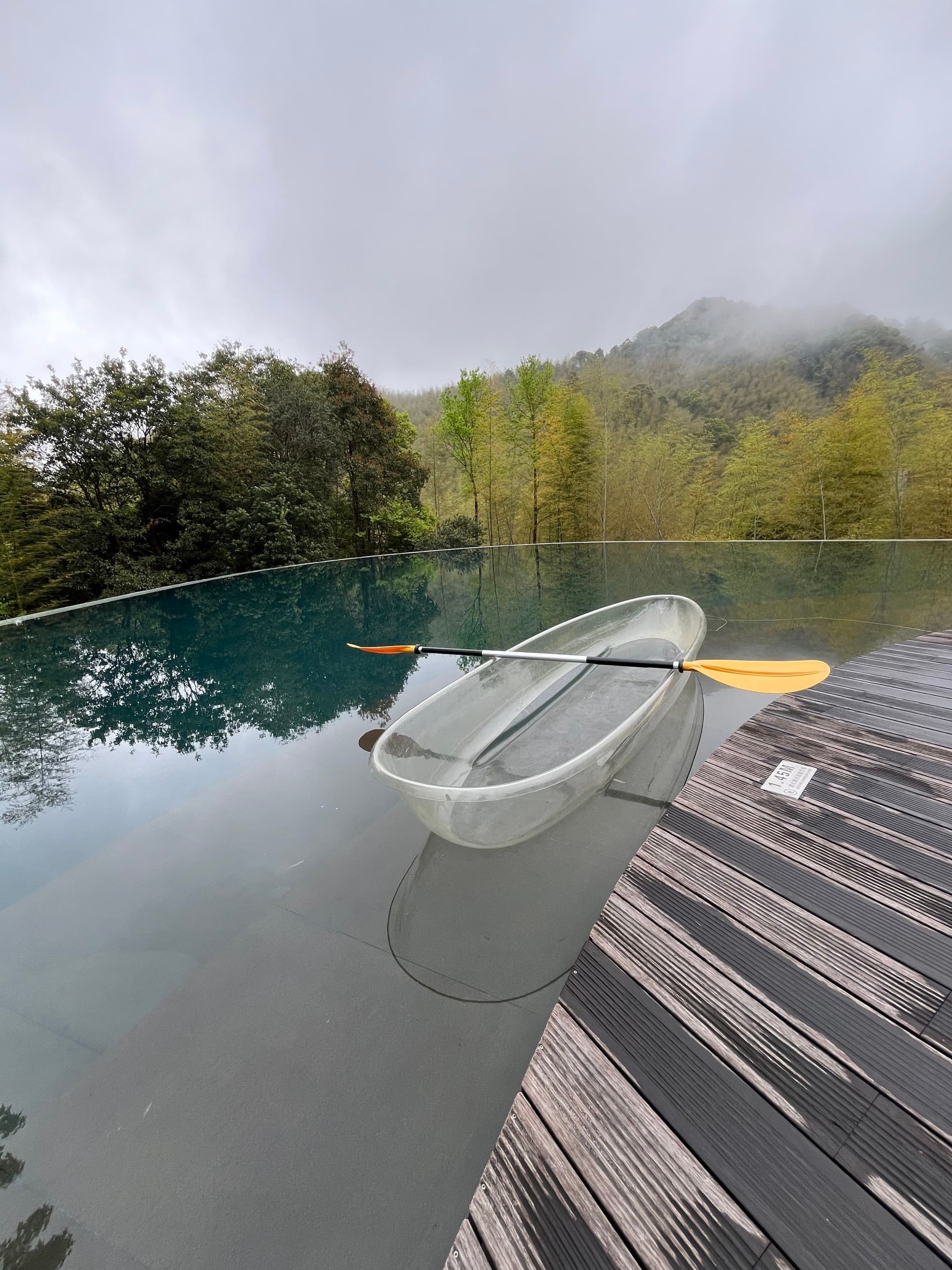 A clear kayak boat on a botty of water during the day