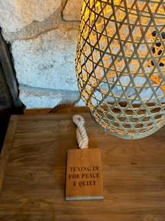 A view of a table lamp and wooden door sign