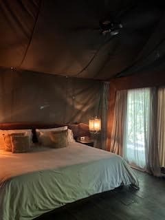 A view of a tent-style hotel room in neutral colors