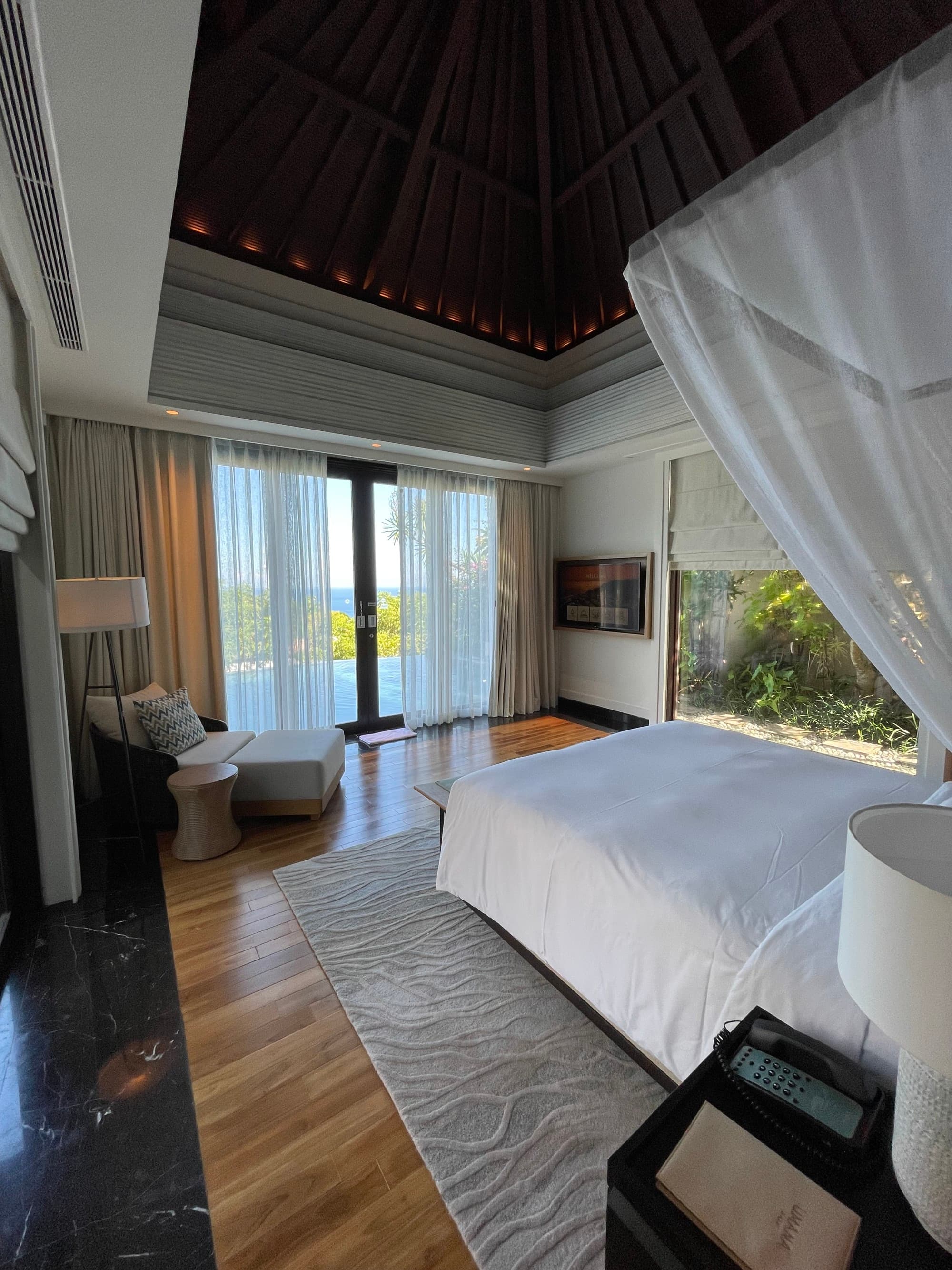 A villa bedroom with a white bed in the middle