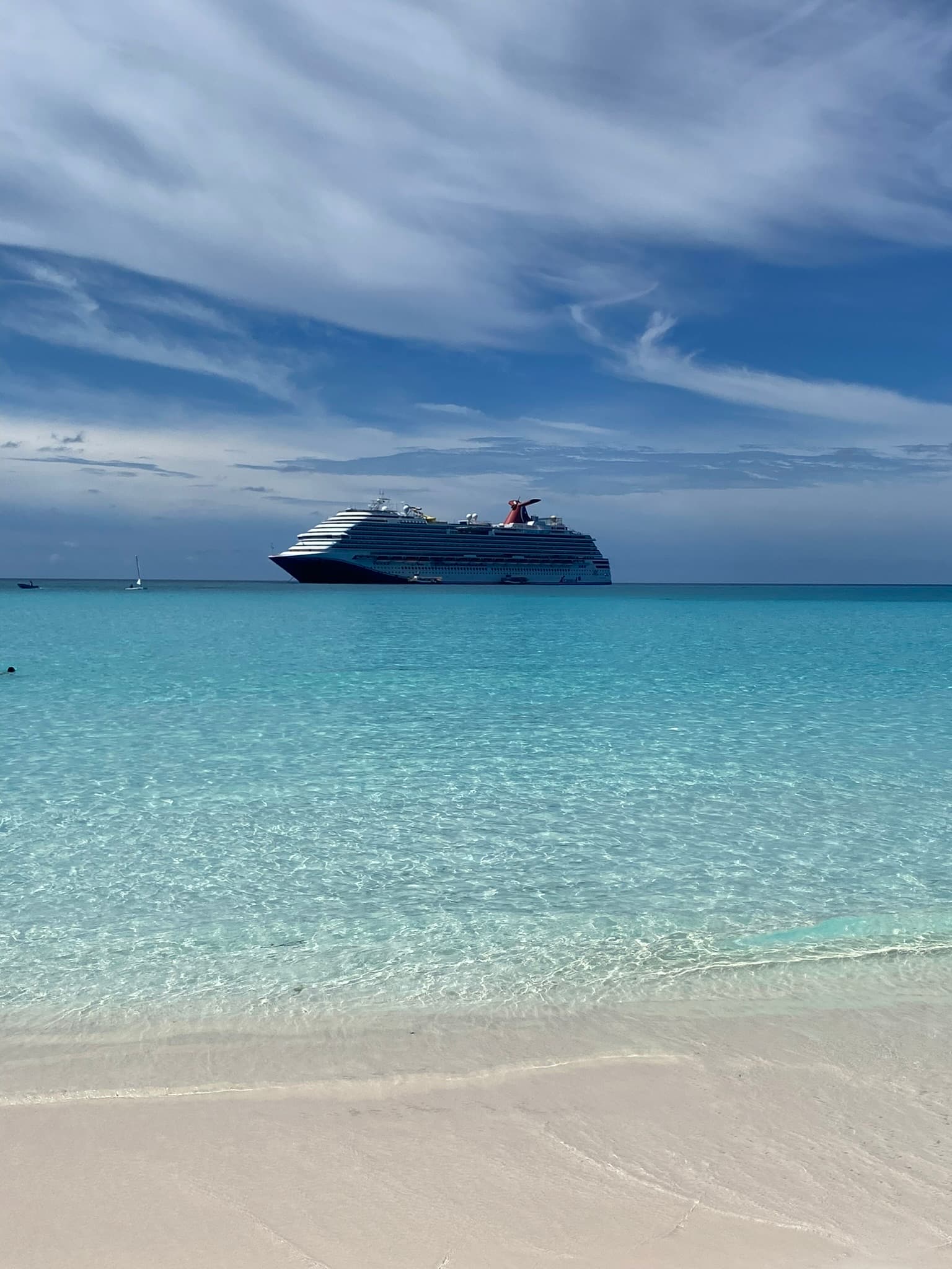 View from a beach of a cruise ship in the water