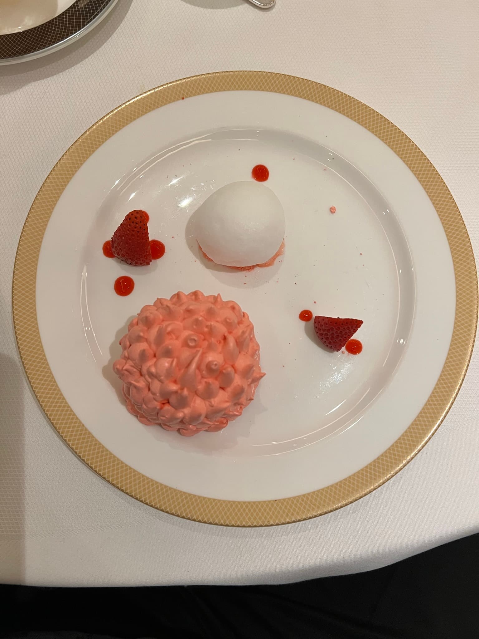 A plate of light-colored and whimsical desserts on a round, white plate.