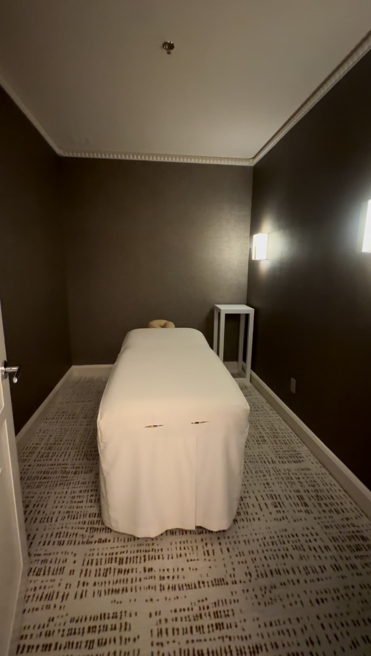 Inside the spa room with a massage table.