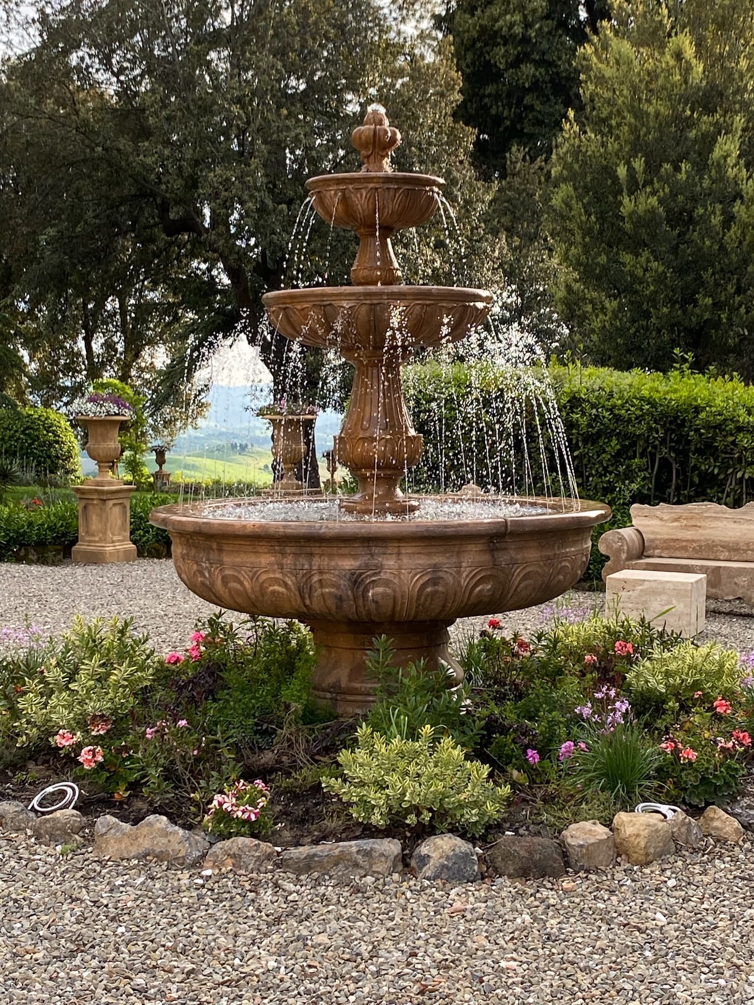 A tiered water fountain in Castelfalfi in a garden