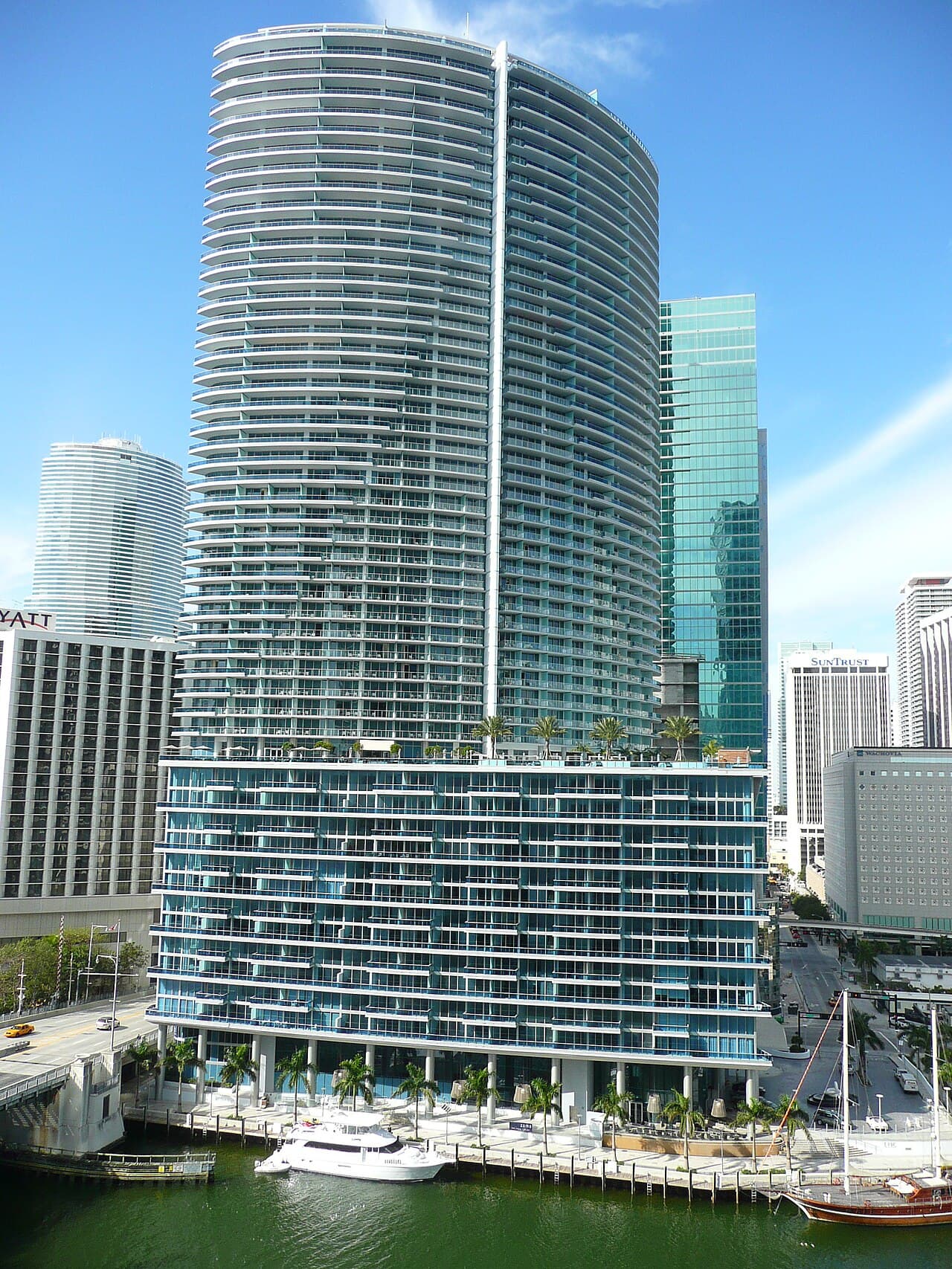 A glass skyscraper on the water's edge.