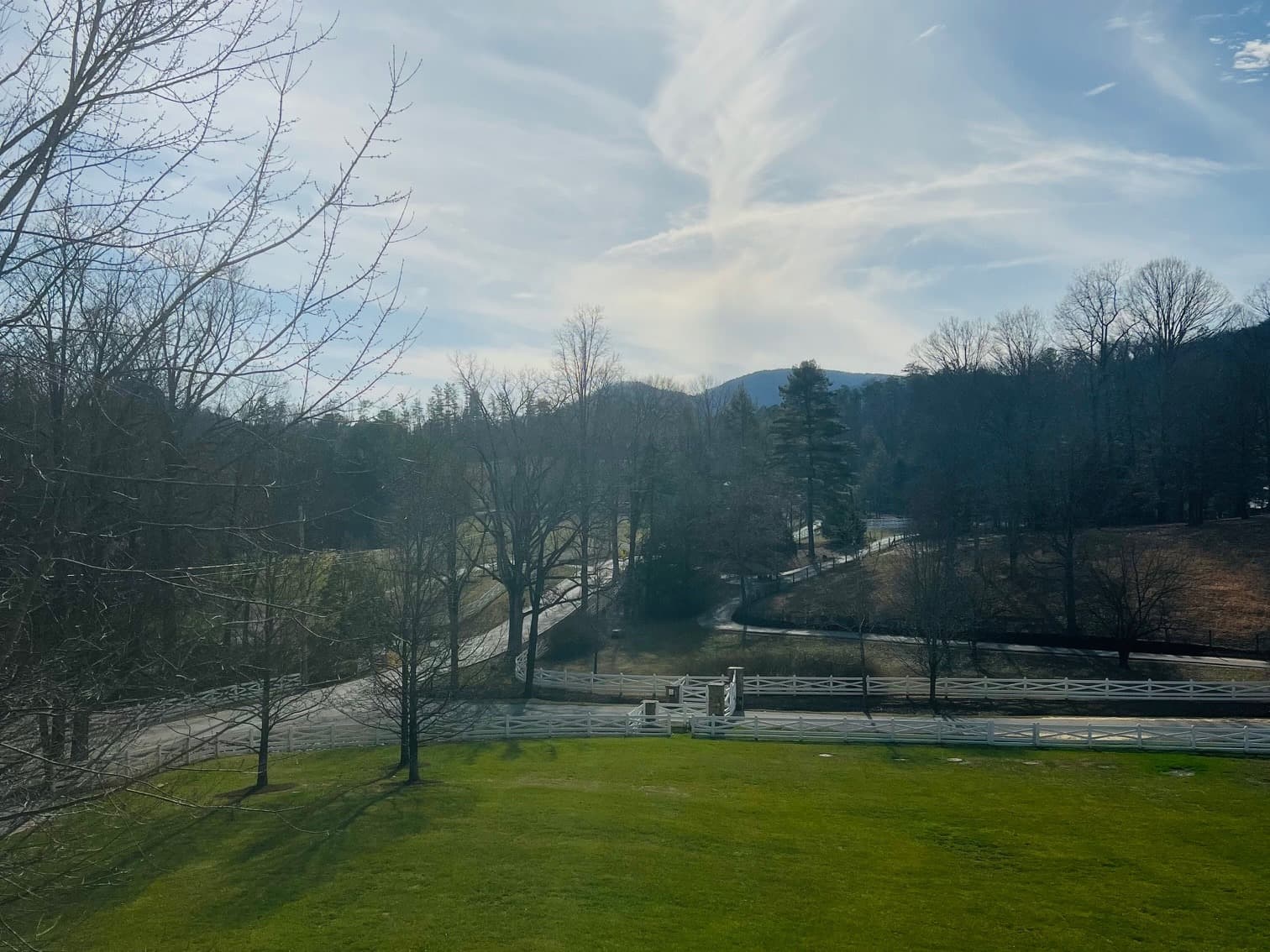 Rolling blue mountains and green lawn.