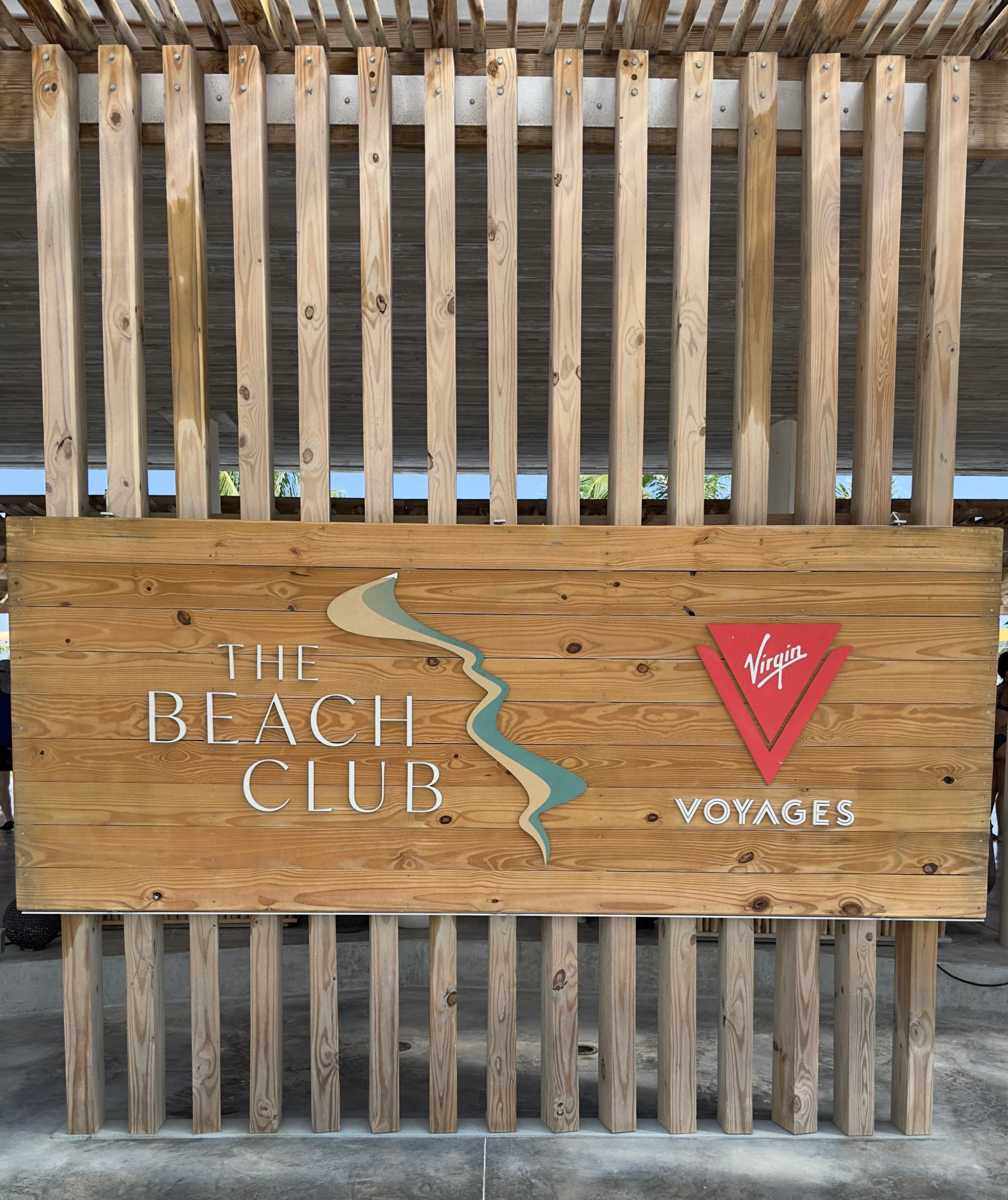 A wooden sign for the Virgin Voyages Beach Club at Bimini - Kelsey Parry