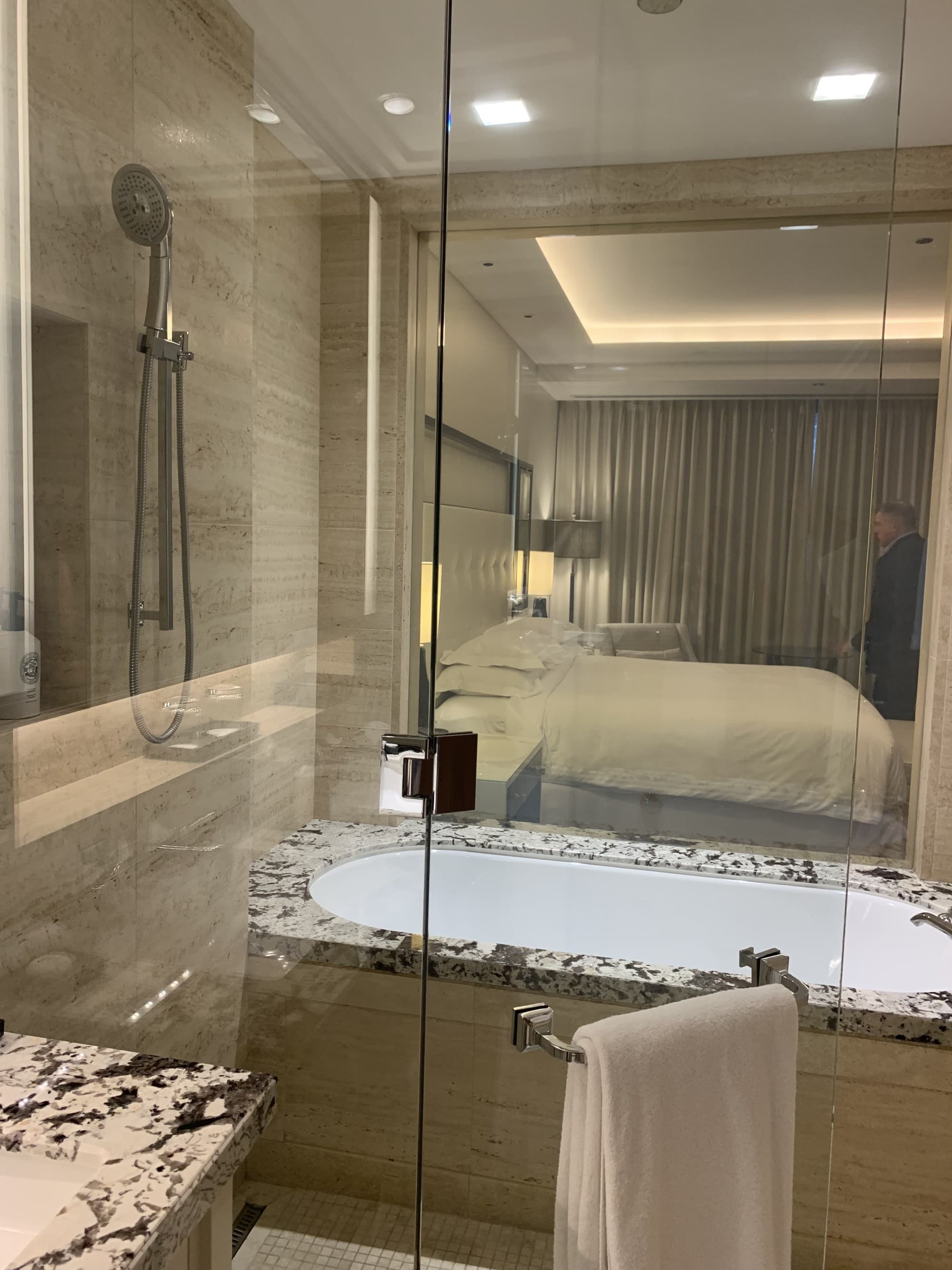 Langham bathroom with glass panel in transparent mode.