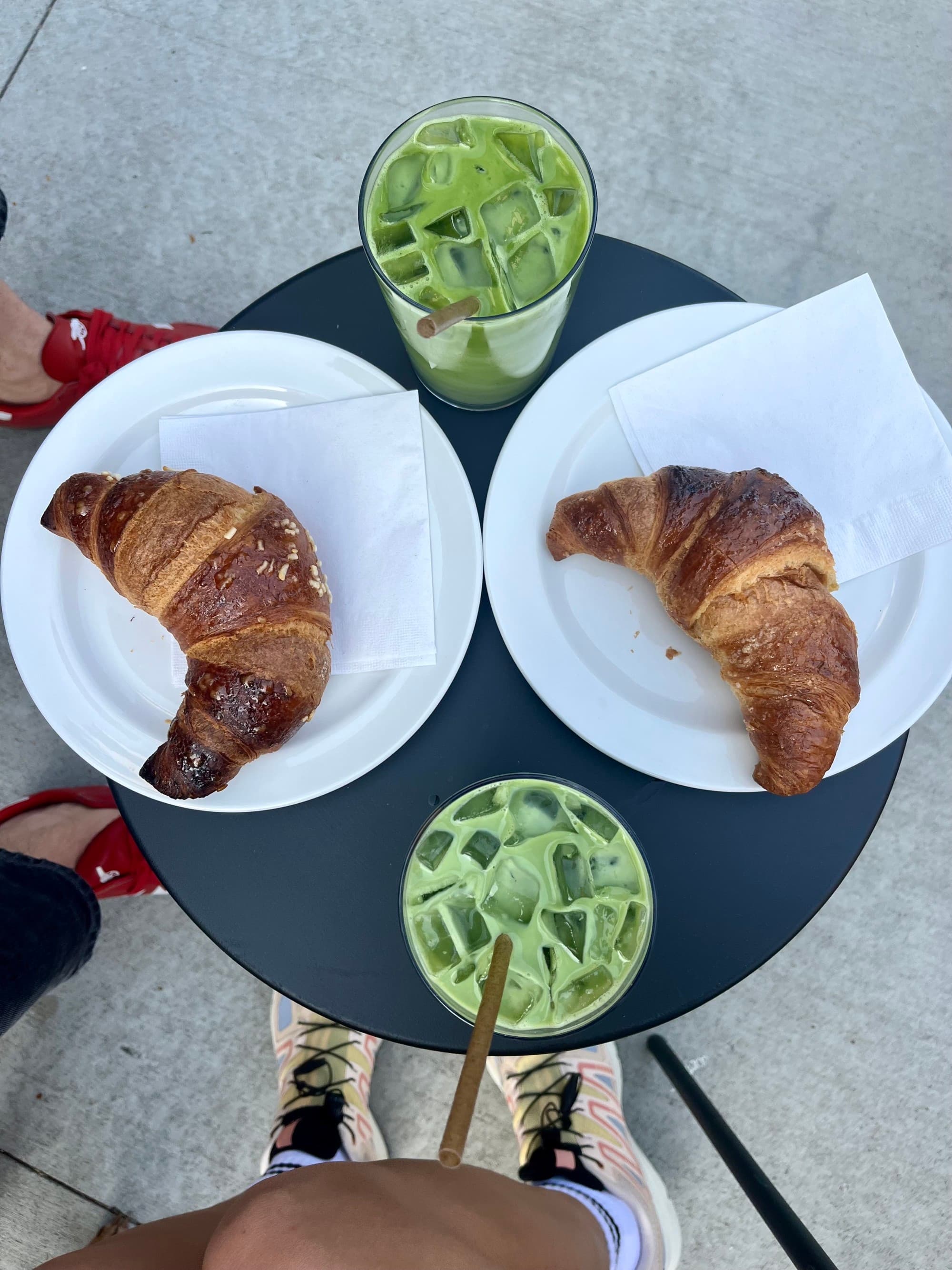 aerial view of croissants and green drinks